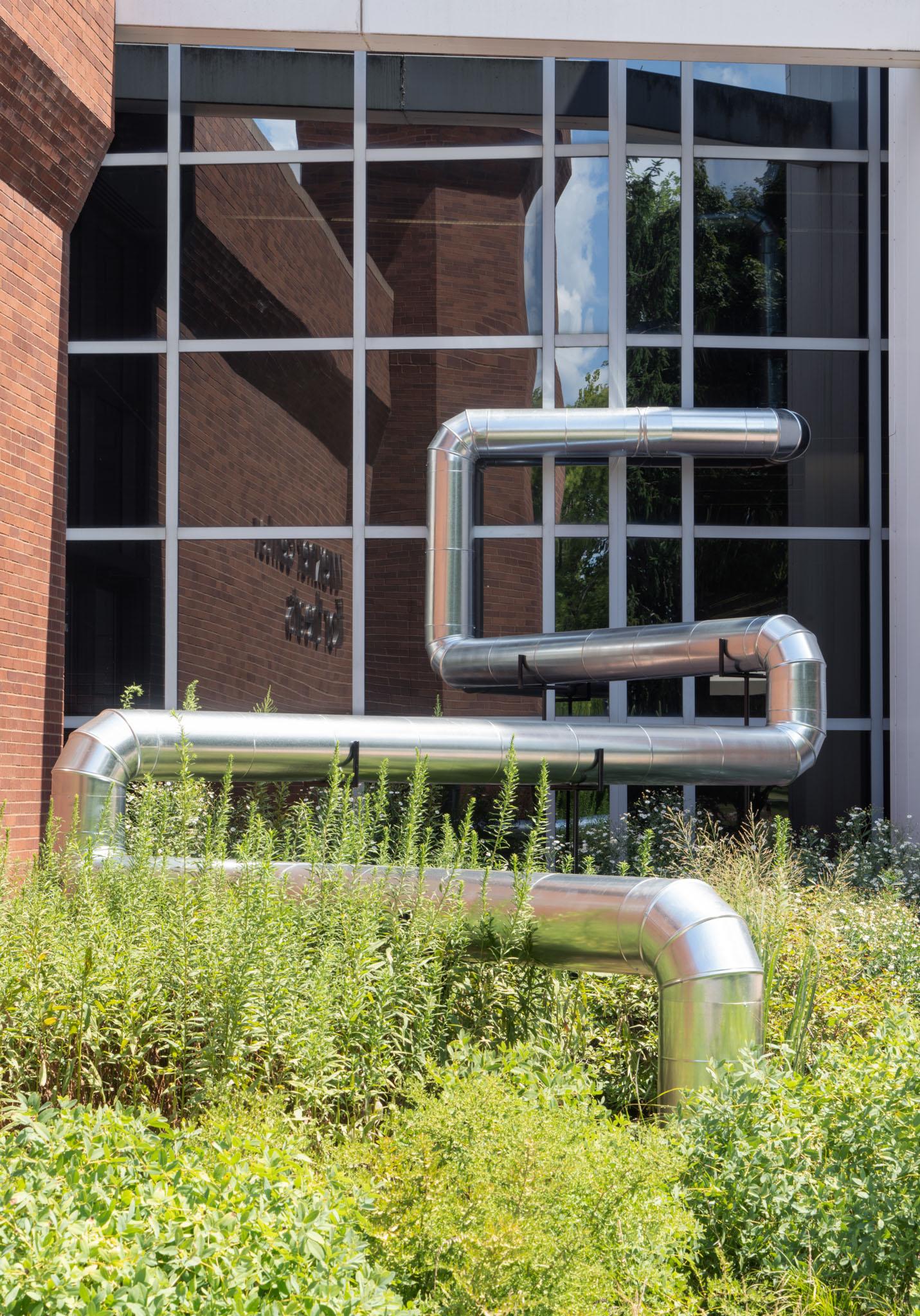 A network of steel duct winding outside a building