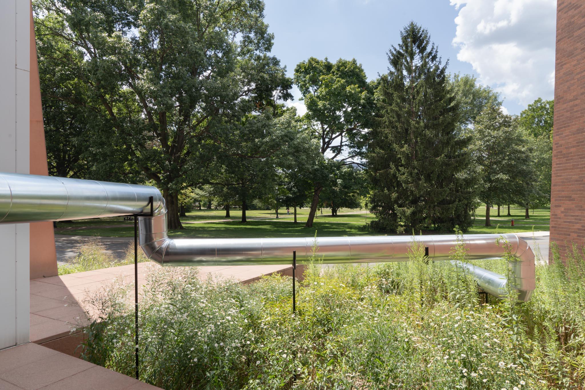 A network of steel duct winding outside a building
