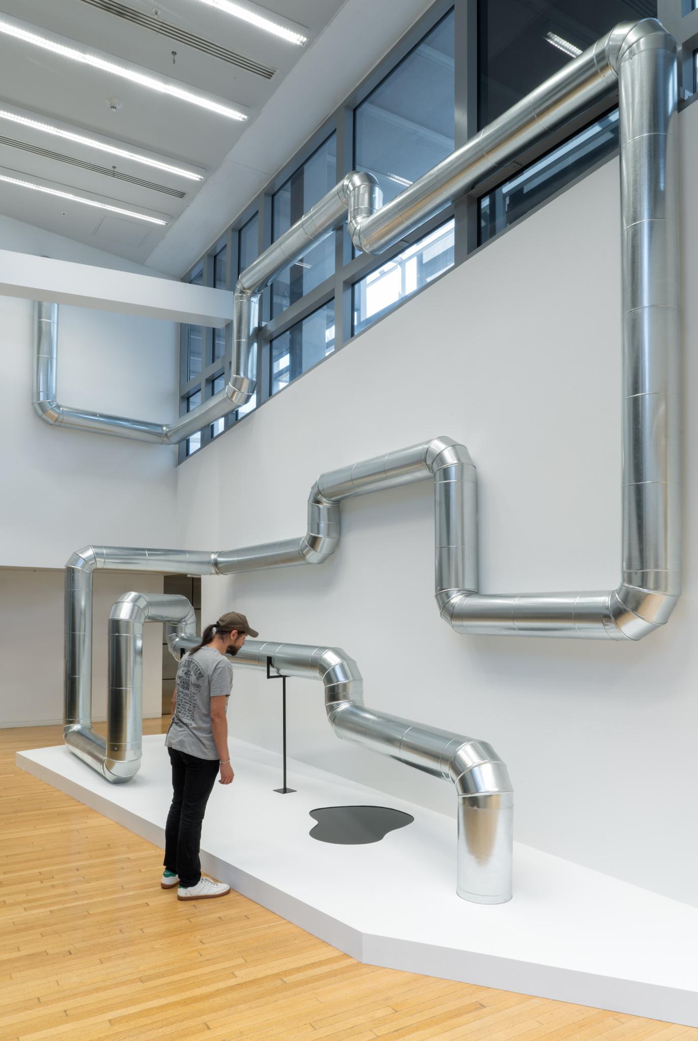 A network of steel duct winding through a building