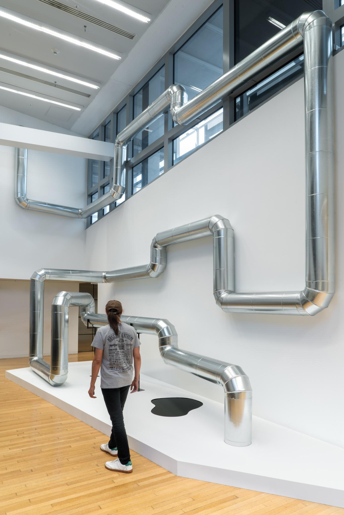 A network of steel duct winding through a building