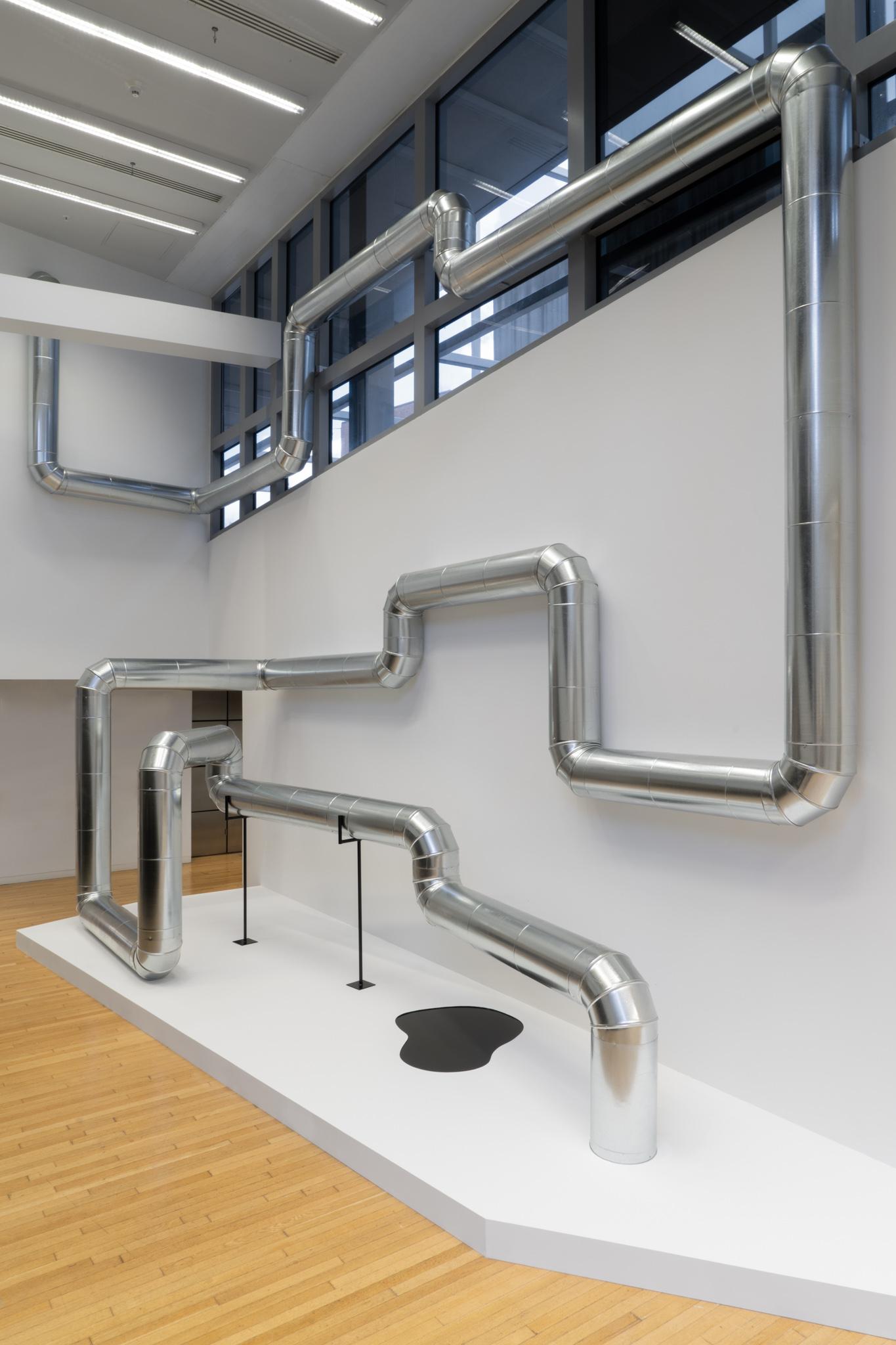 A network of steel duct winding through a building