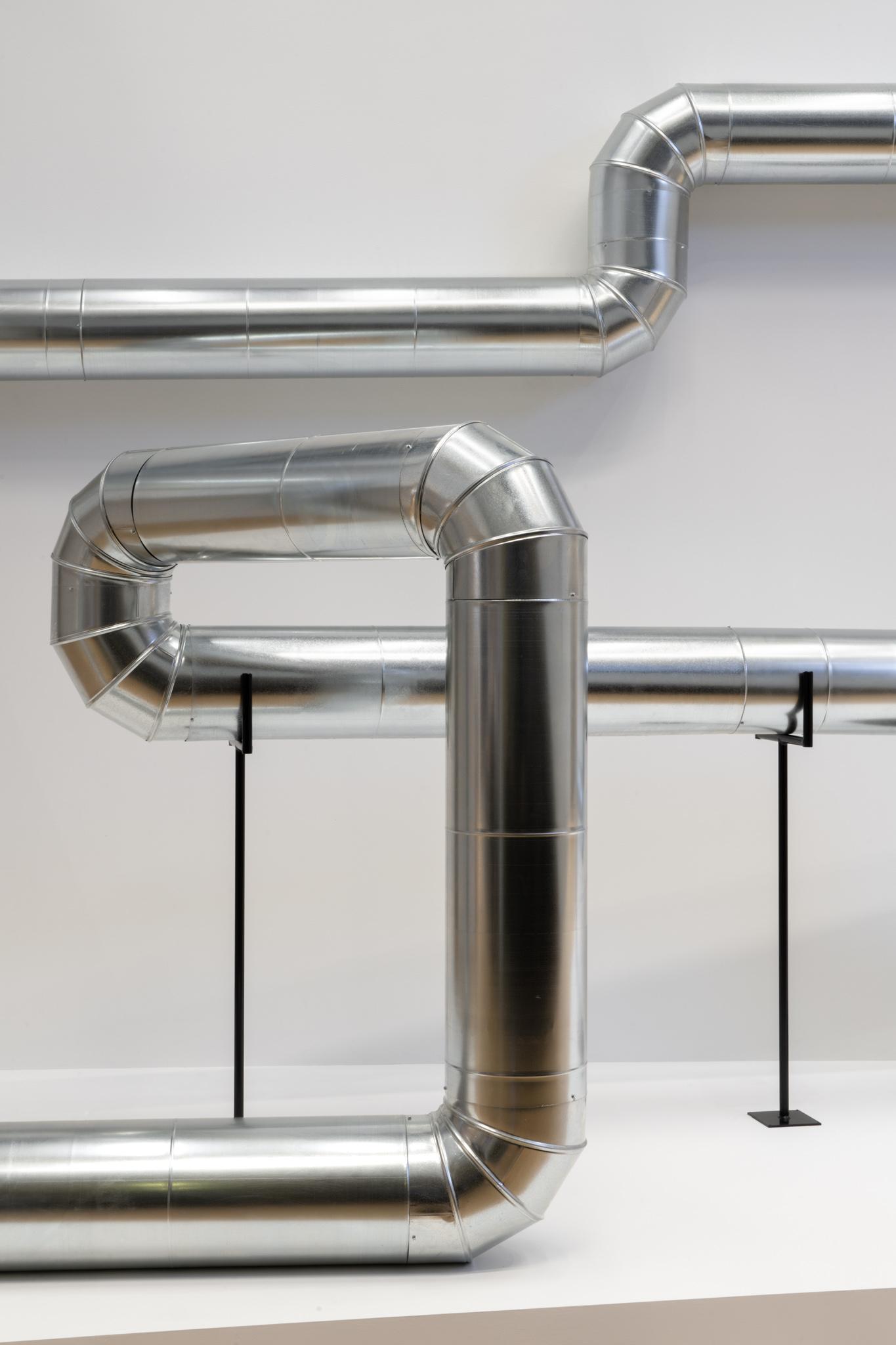 A network of steel duct winding through a building