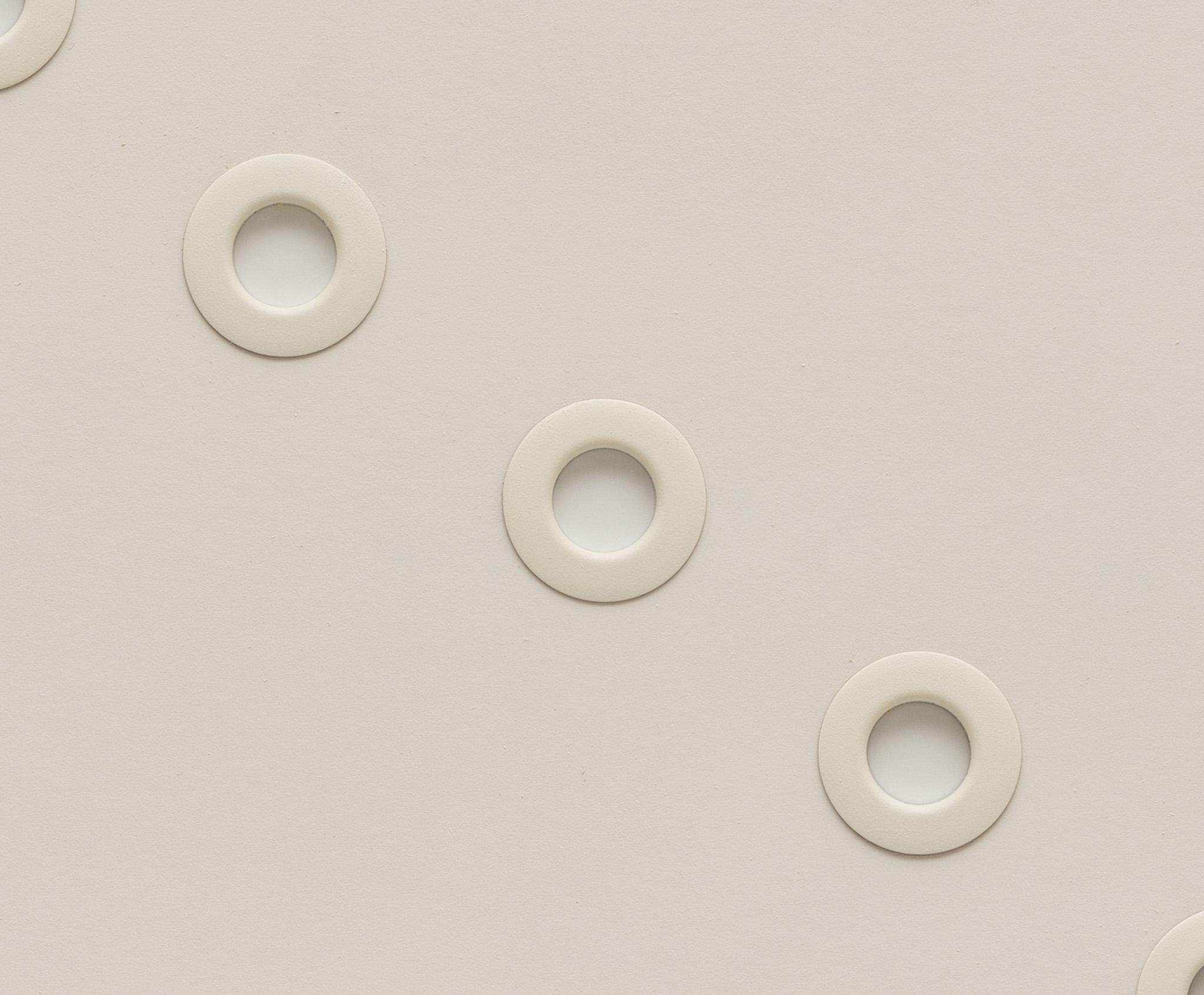 white circular grommets through foamcore arranged in a diagonal line