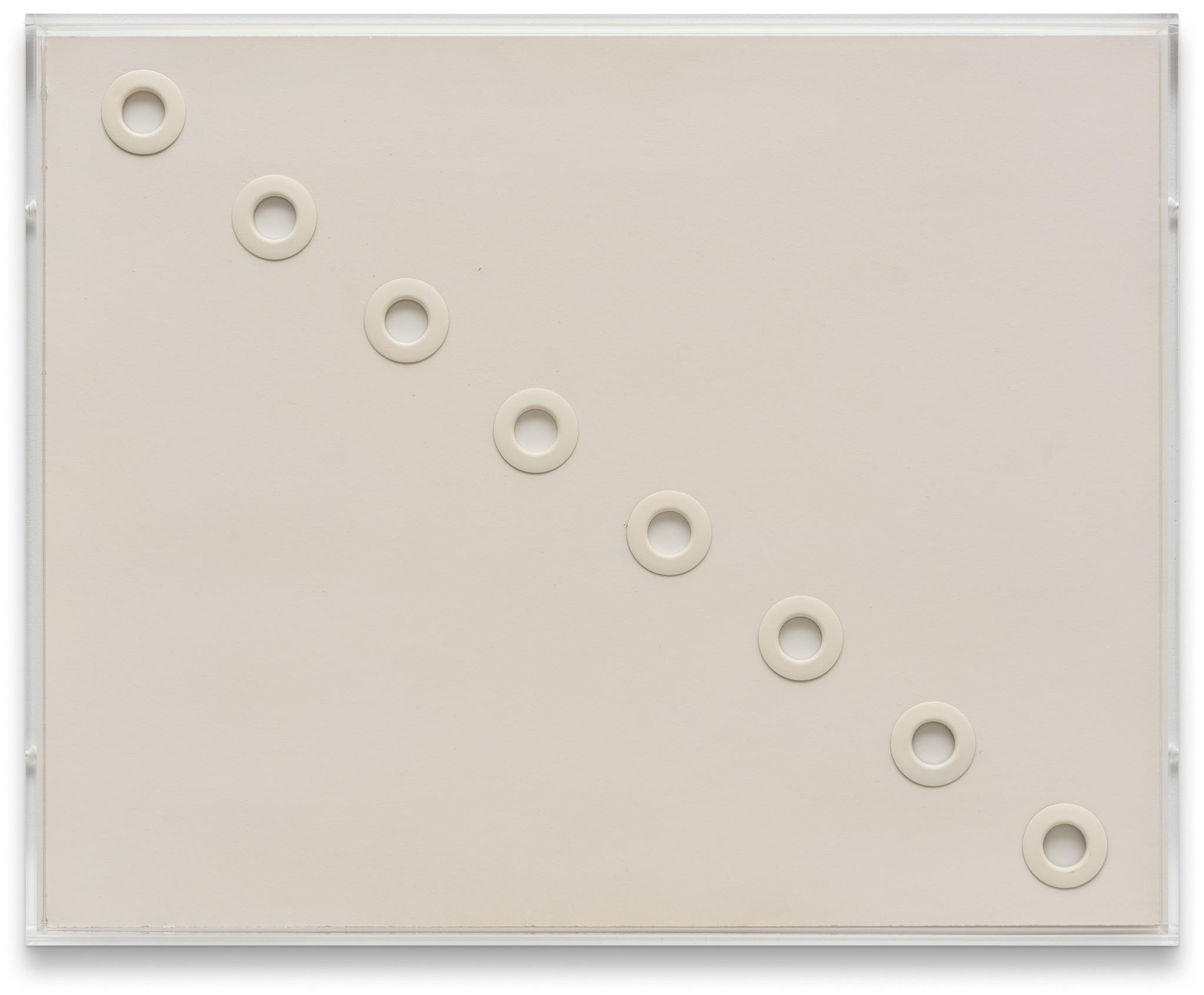 white circular grommets through foamcore arranged in a diagonal line