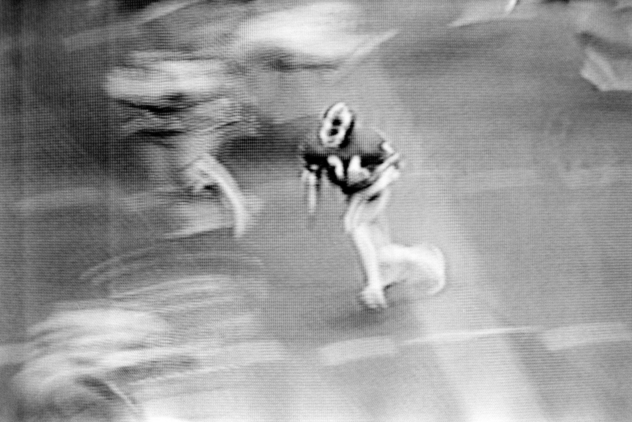 images of a broadcast professional football game showing the grain of the television