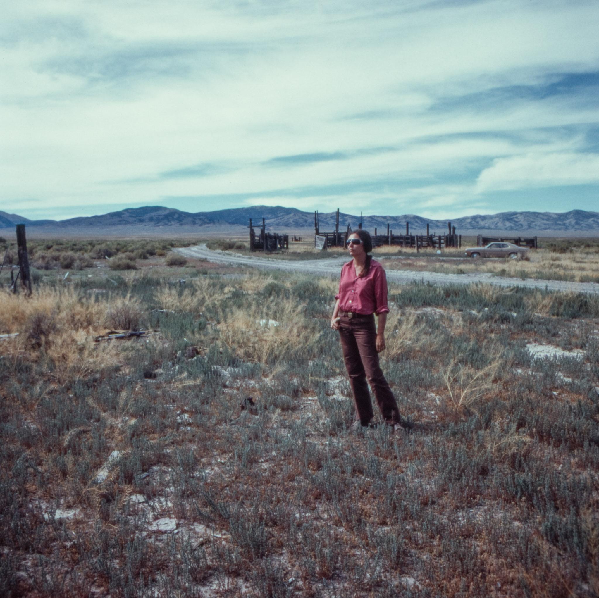 Nancy Holt standing beside a road in Utah