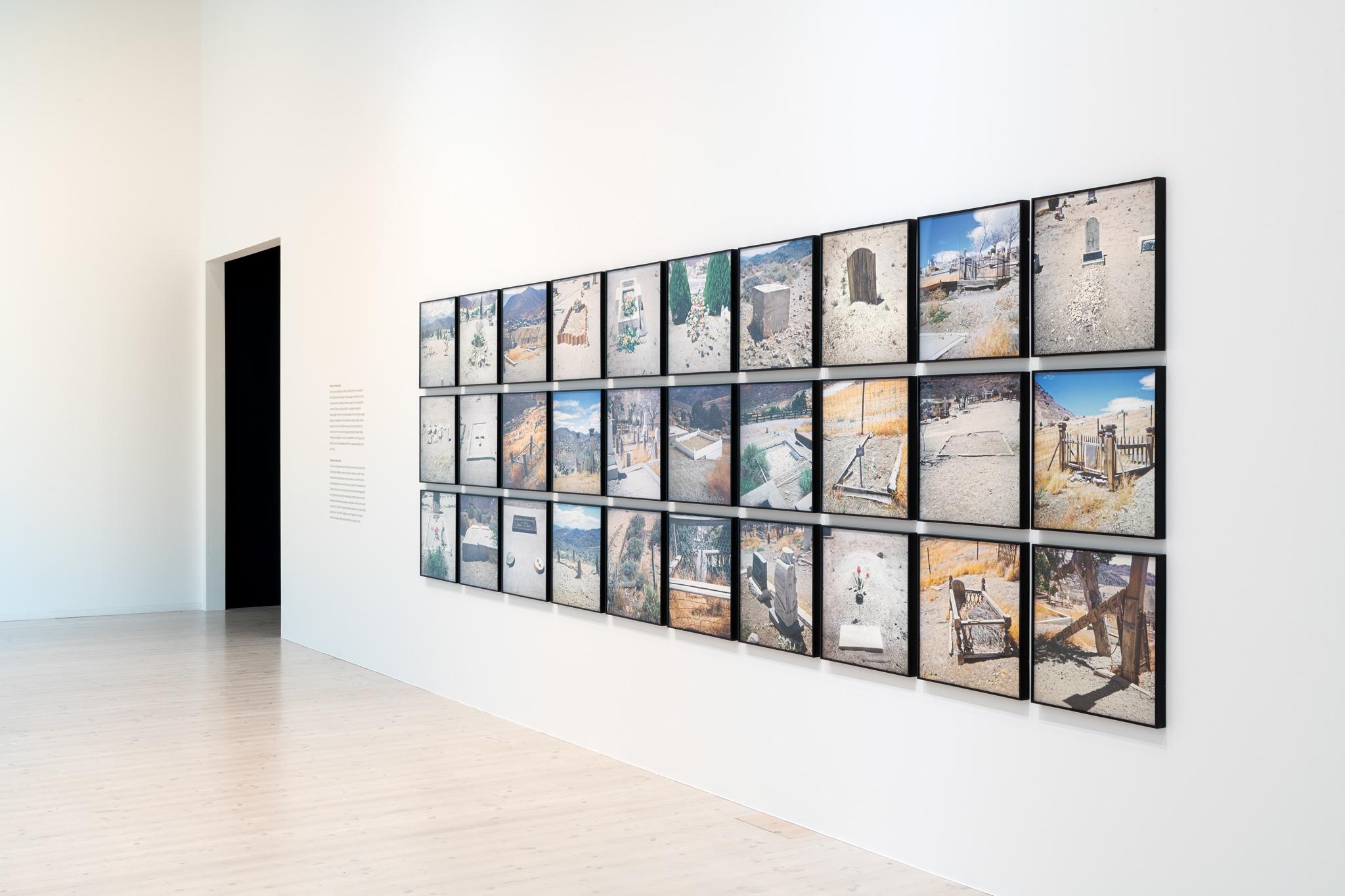 framed photographs of western graveyards on a gallery wall