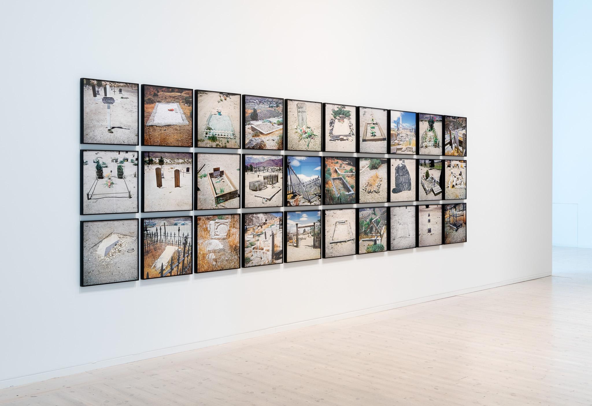 framed photographs of western graveyards on a gallery wall