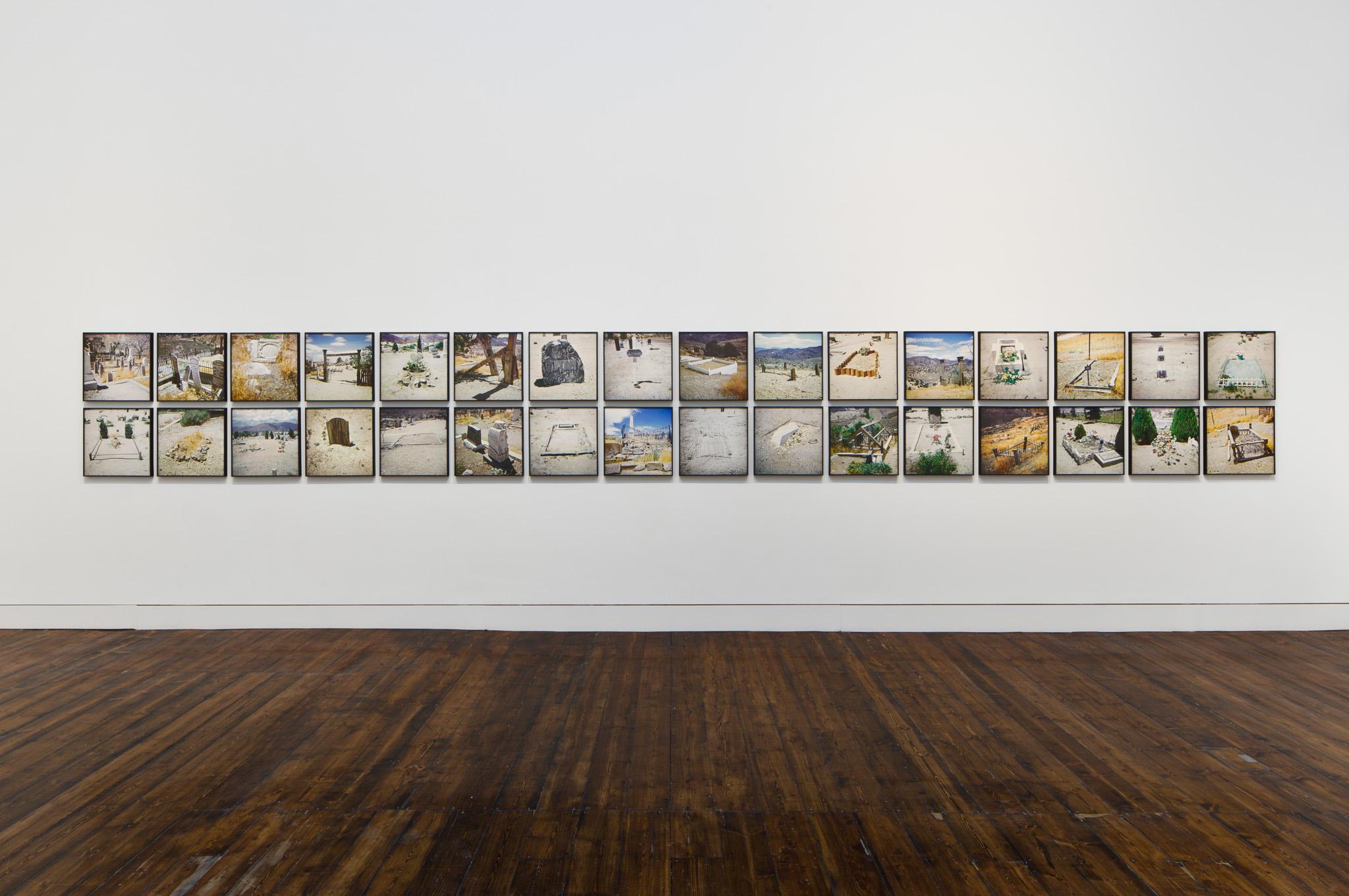 framed photographs of western graveyards on a gallery wall