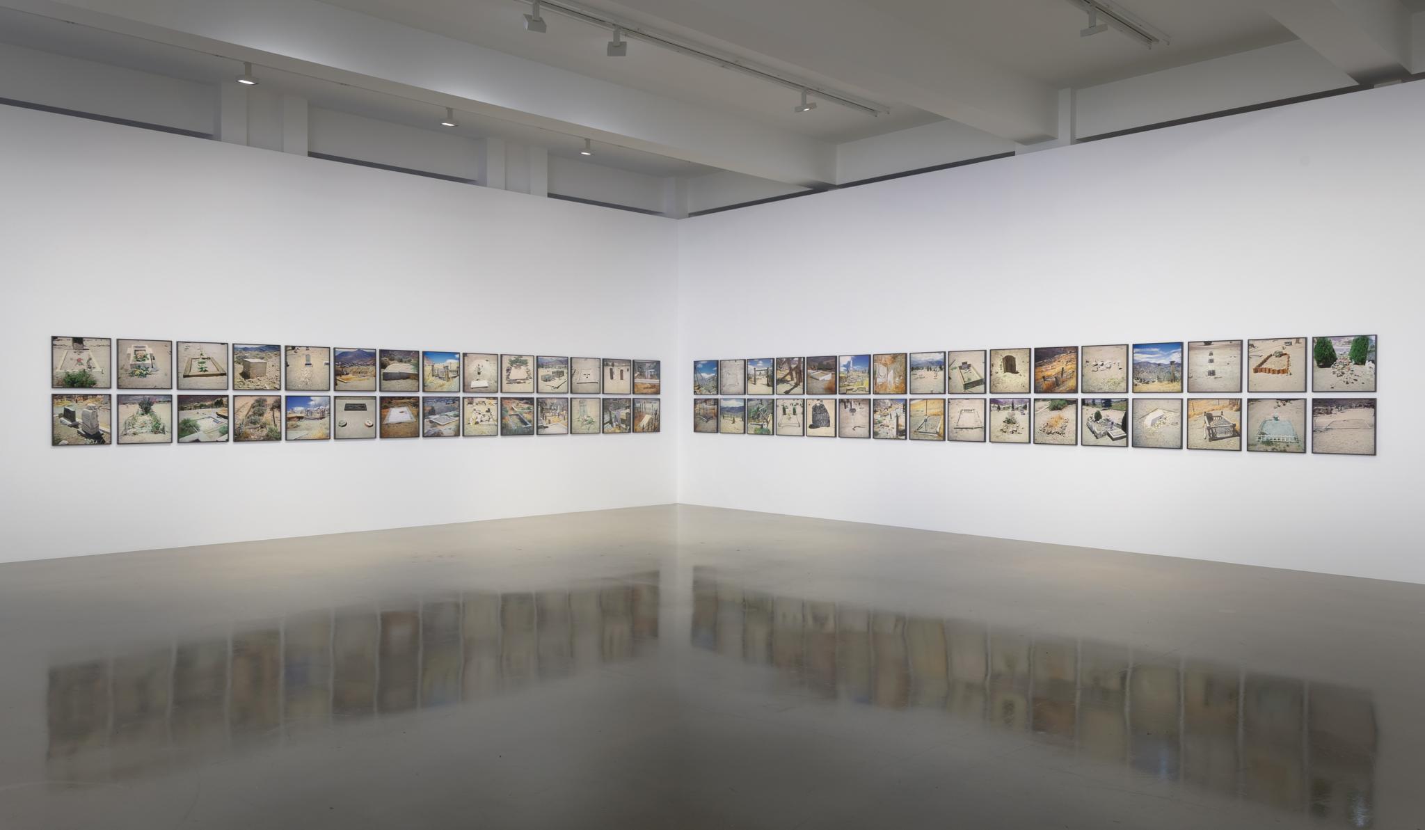 framed photographs of western graveyards on a gallery wall