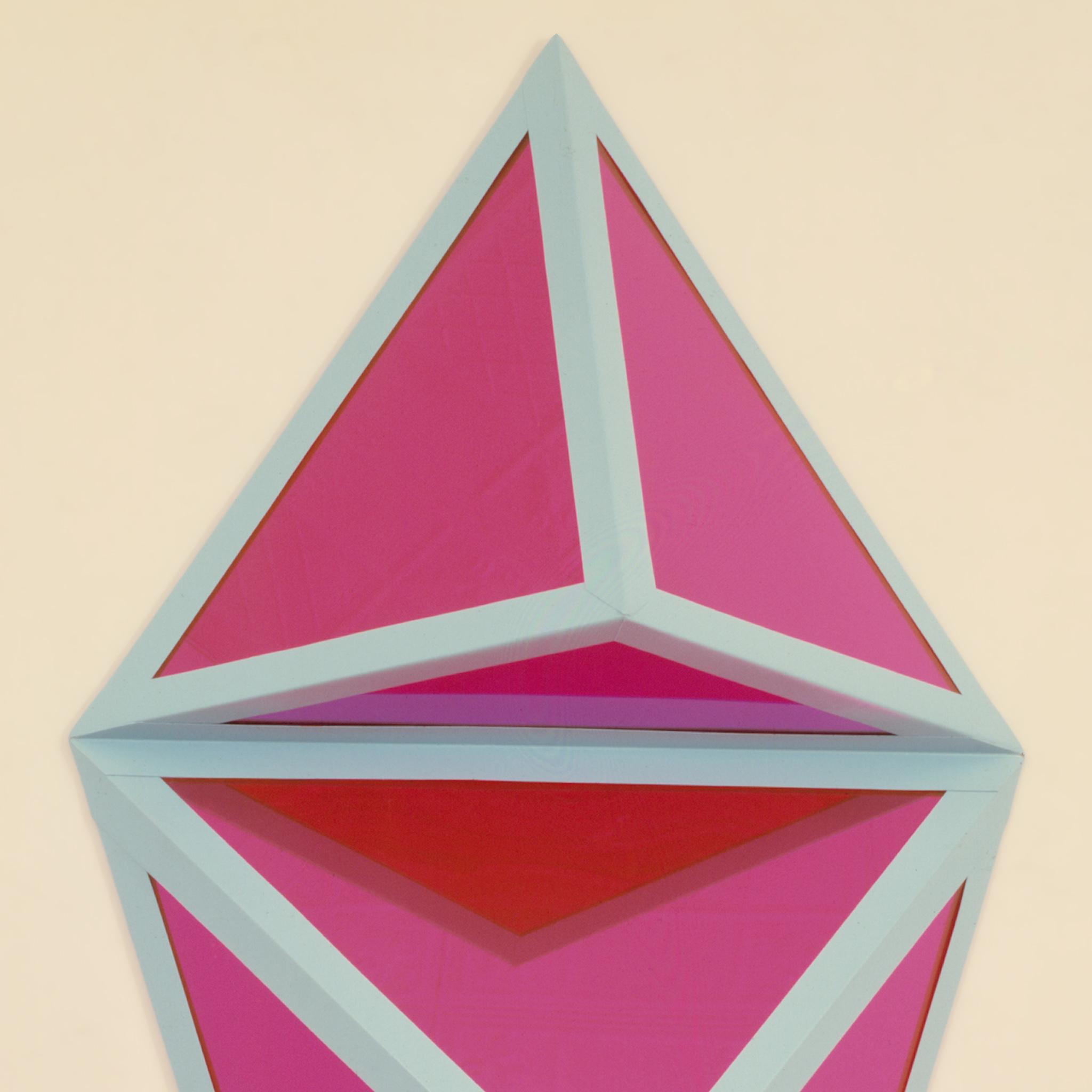 detail image of a geometric sculpture with pale blue metal frame and pink mirrored planes