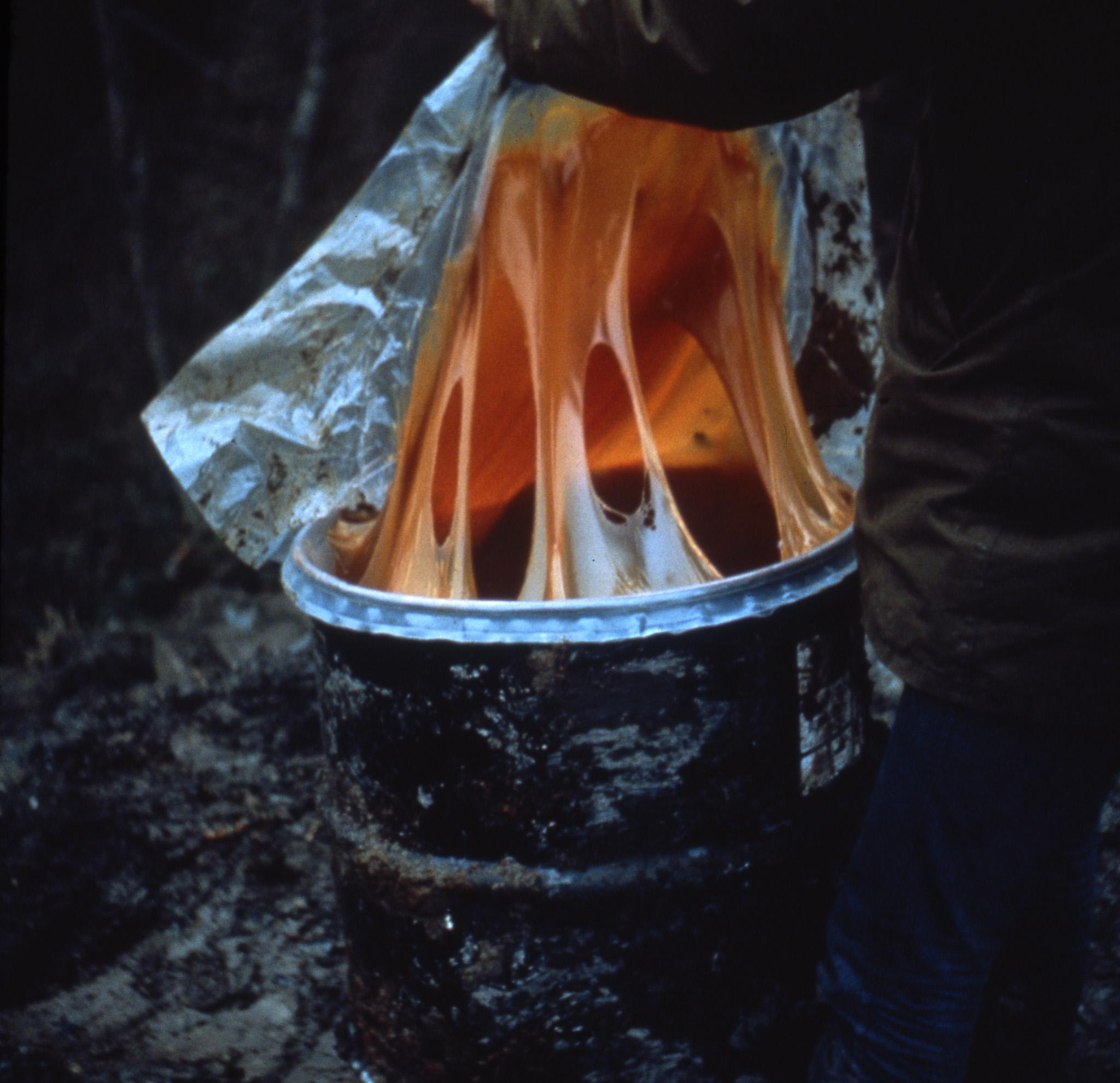 Viscous orange glue in a large barrel