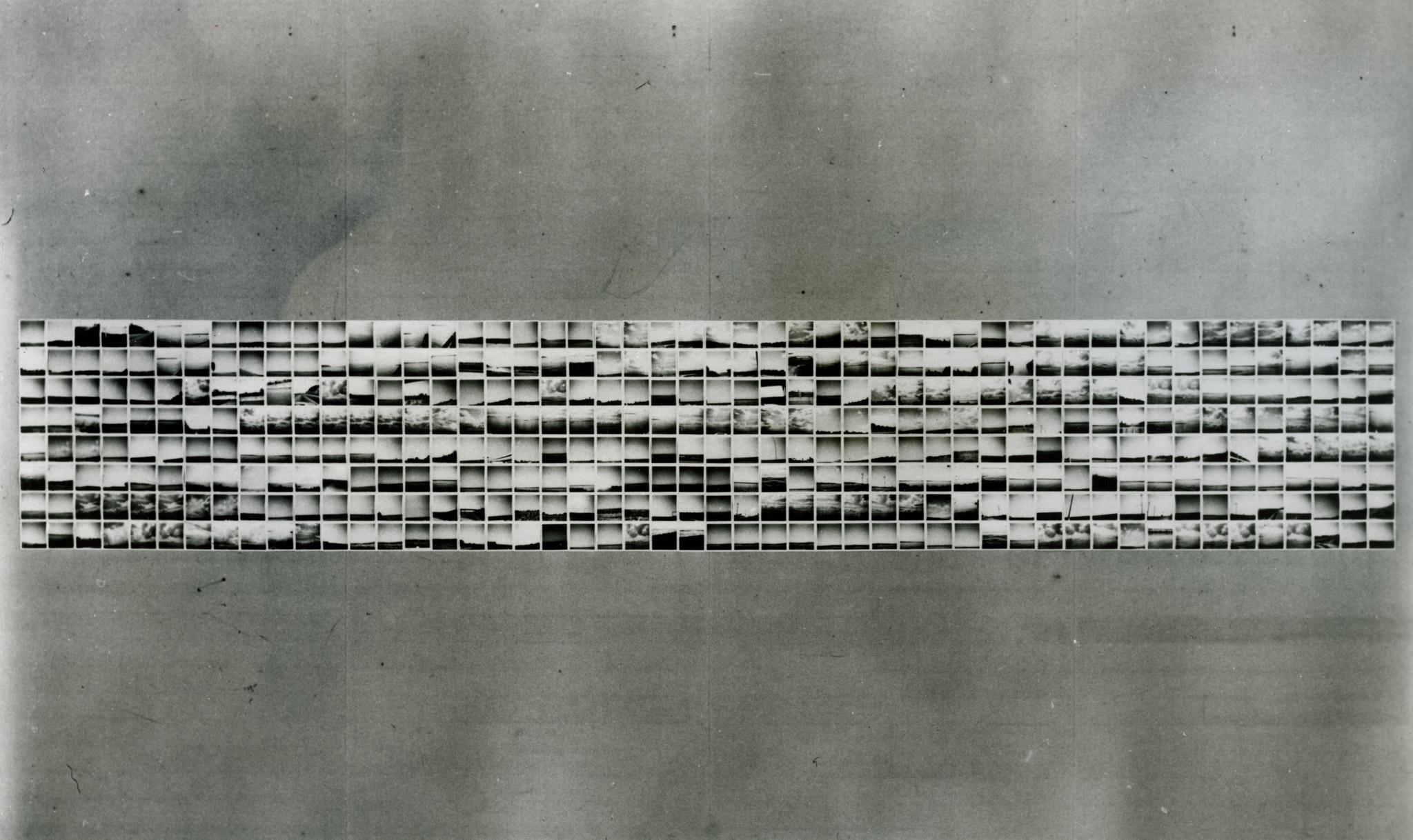 400 small photographic works on a gray wall