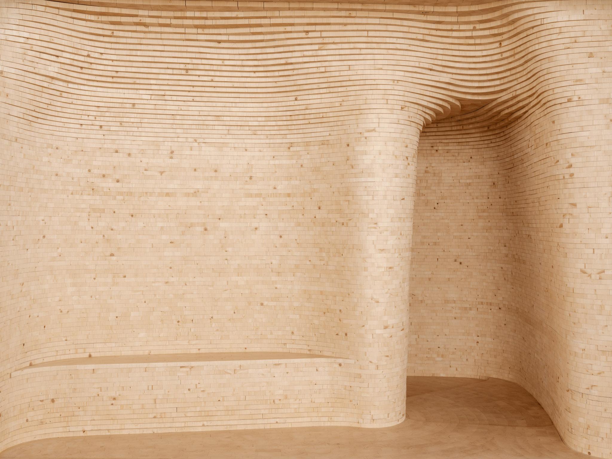 a wooden curving room with an entrance doorway on the right