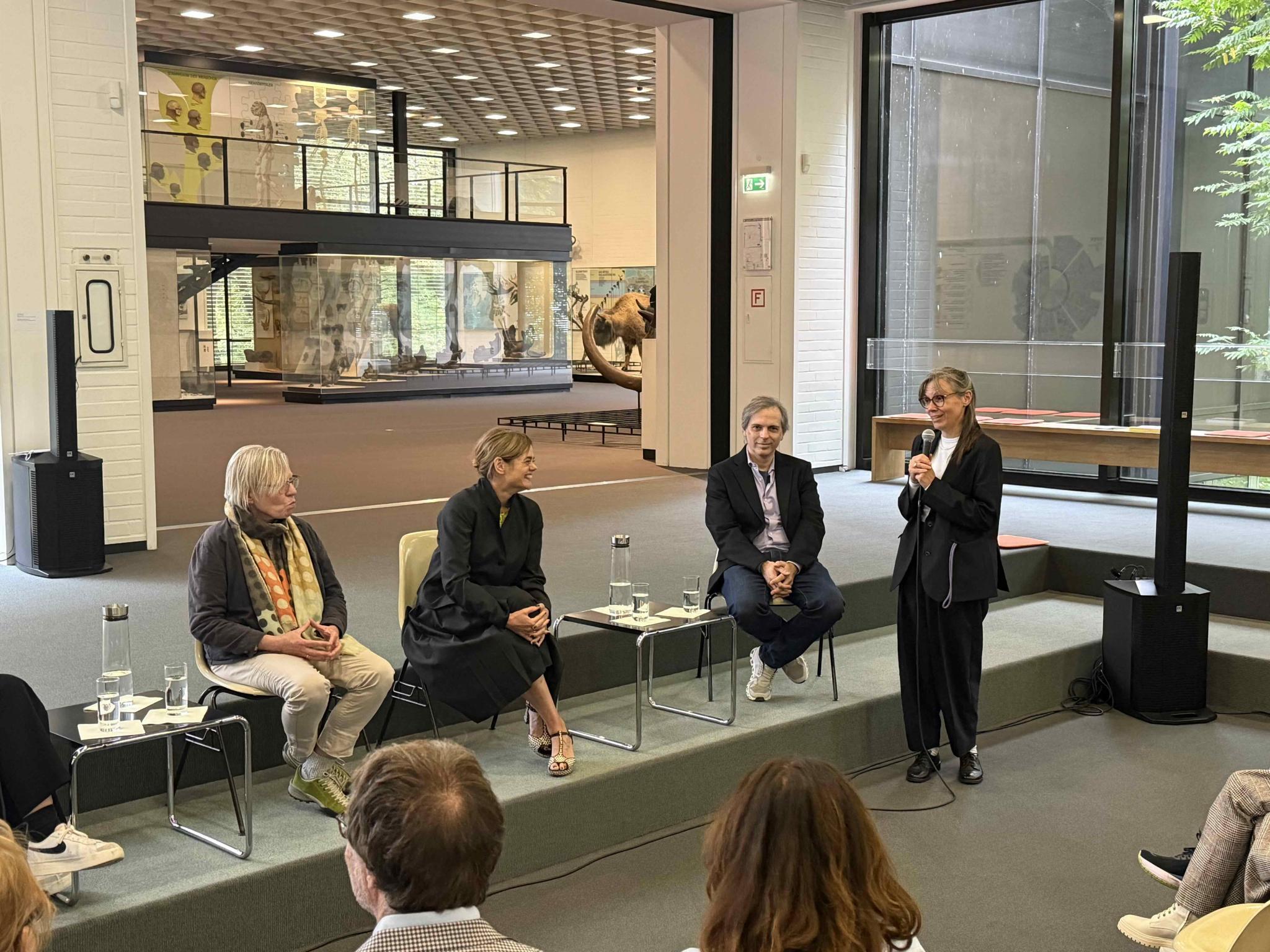 an image of four people talking in a gallery discussion