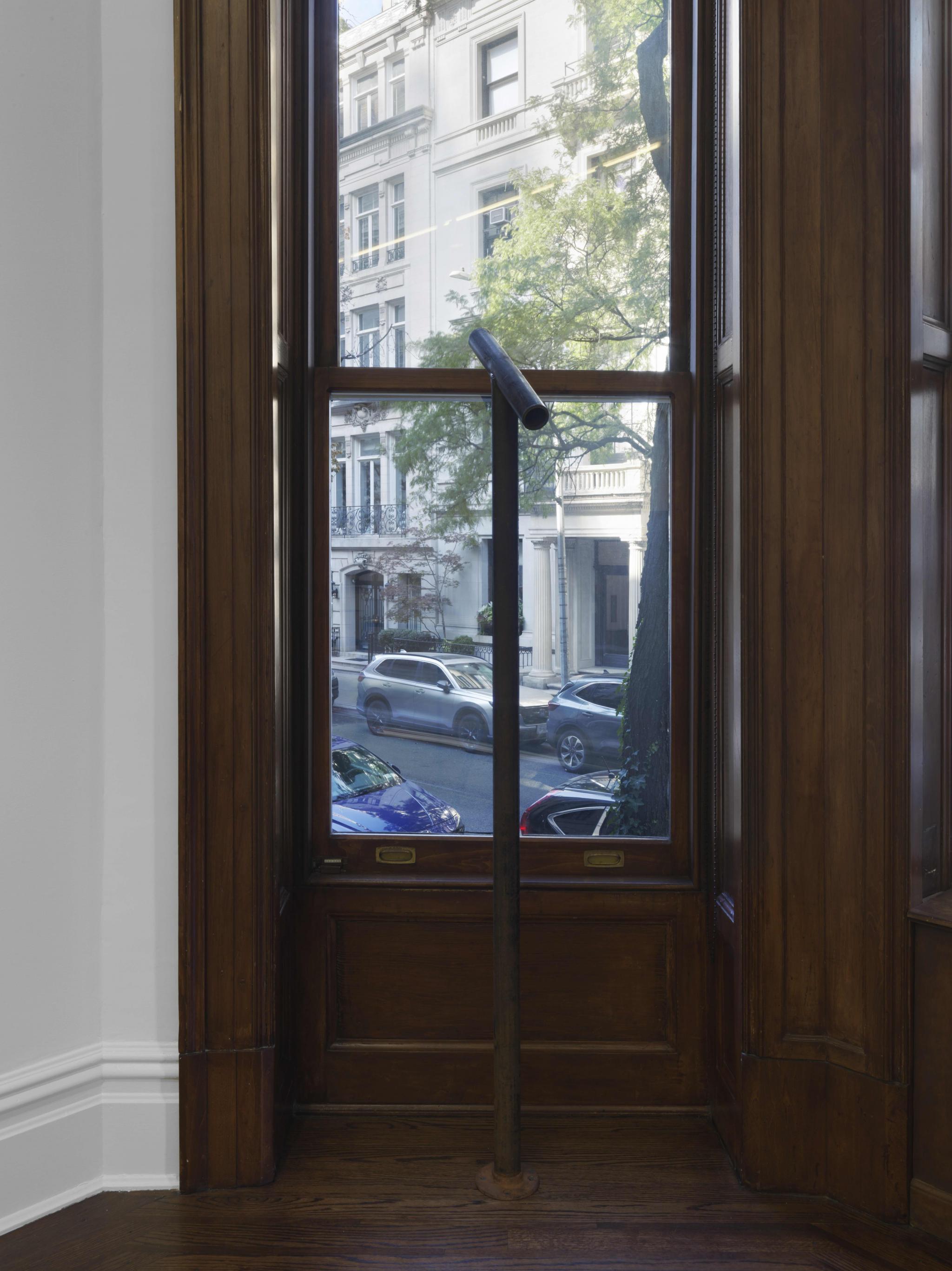 a viewing device looking through a window made of steel pipe