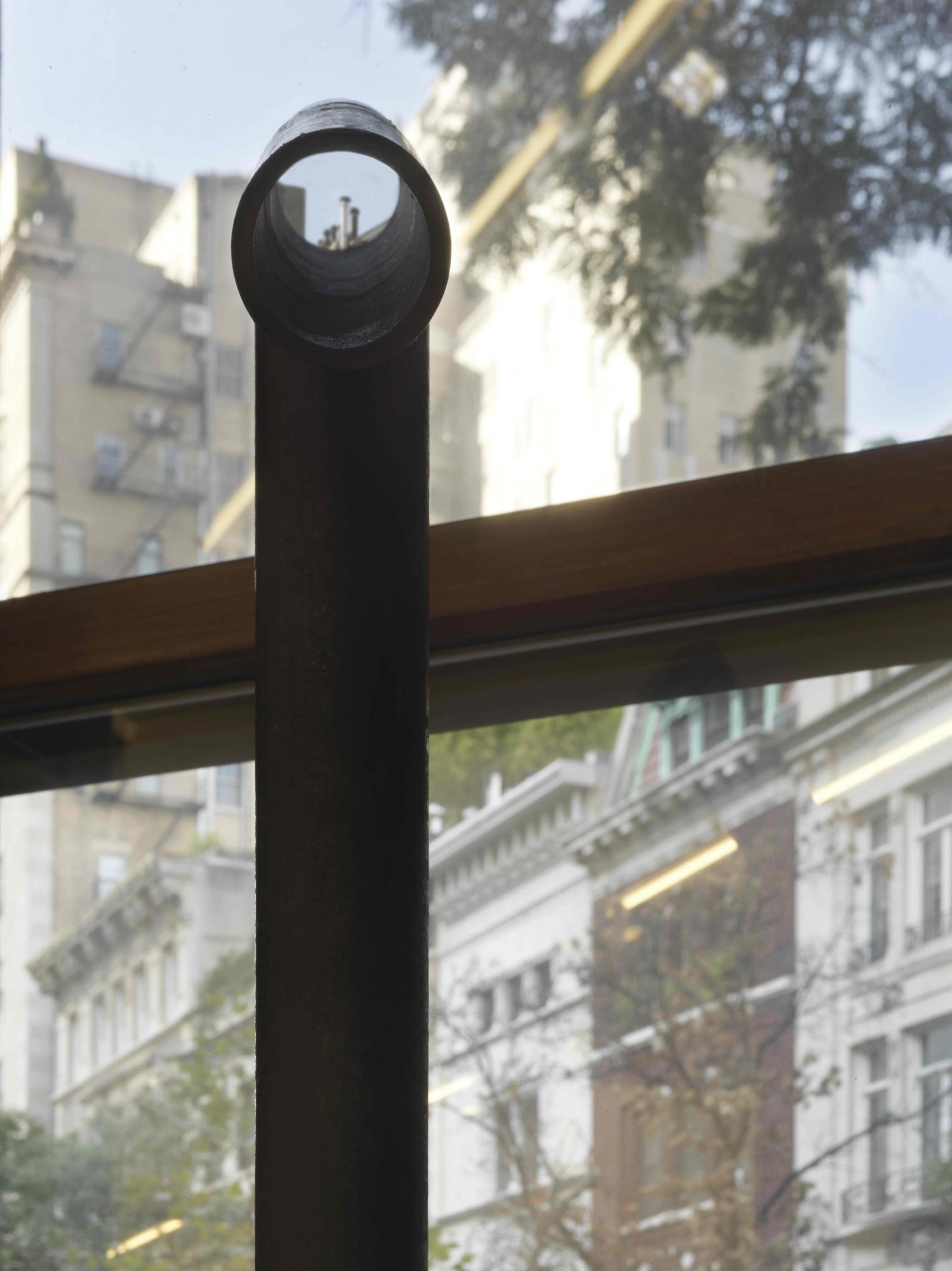 a viewing device looking through a window made of steel pipe