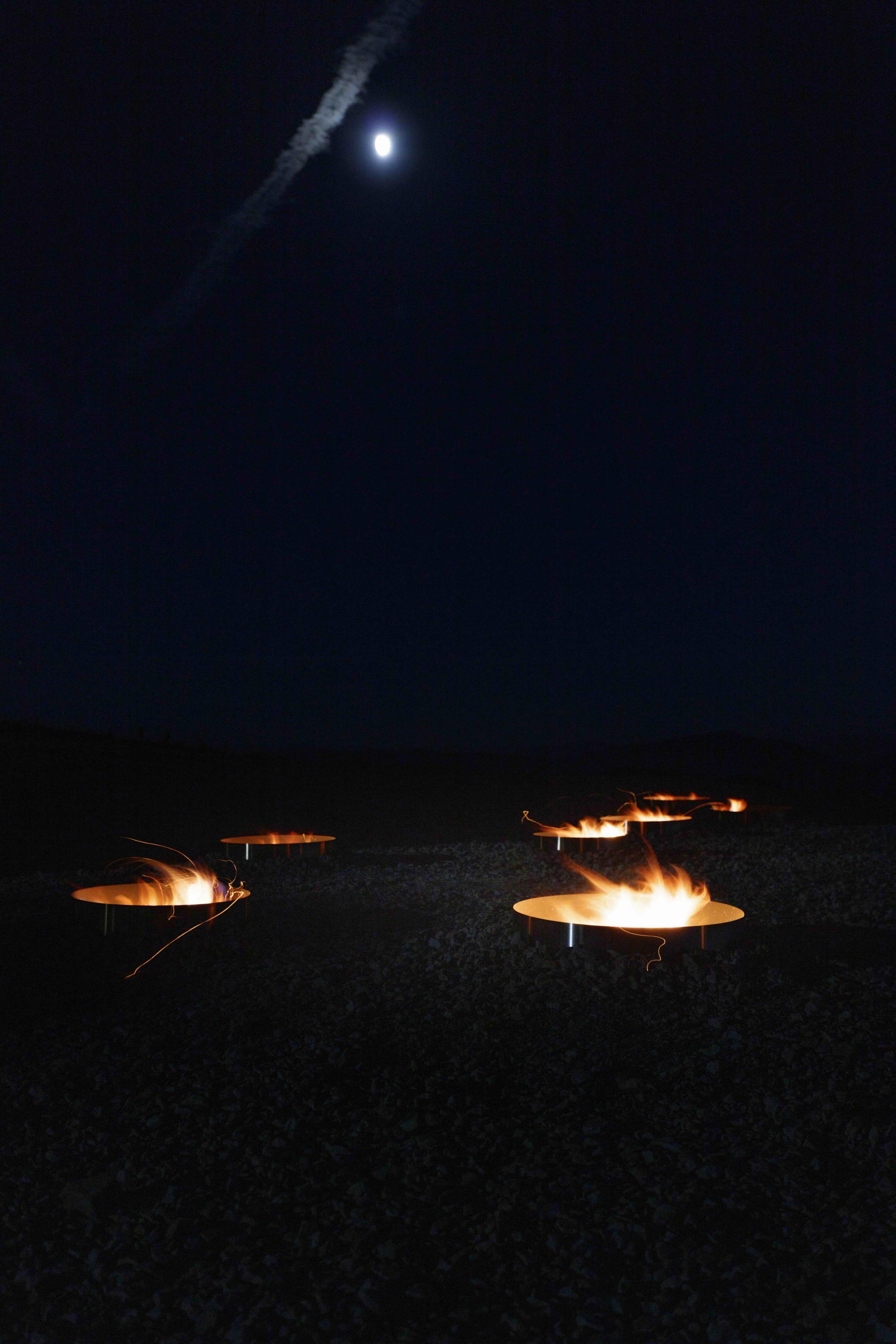 fire pits in the outline of a star constellation