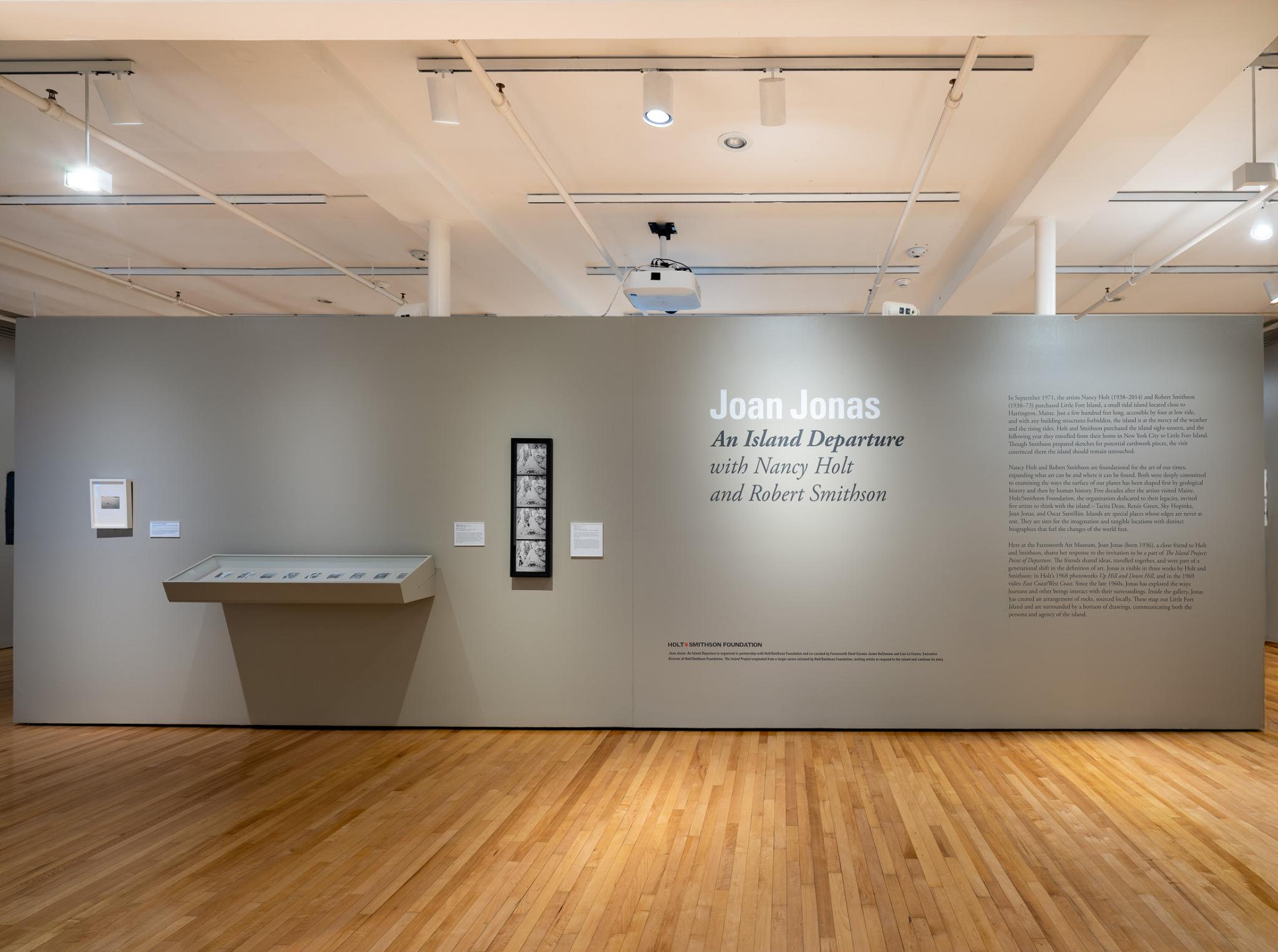 a grey wall presenting artworks