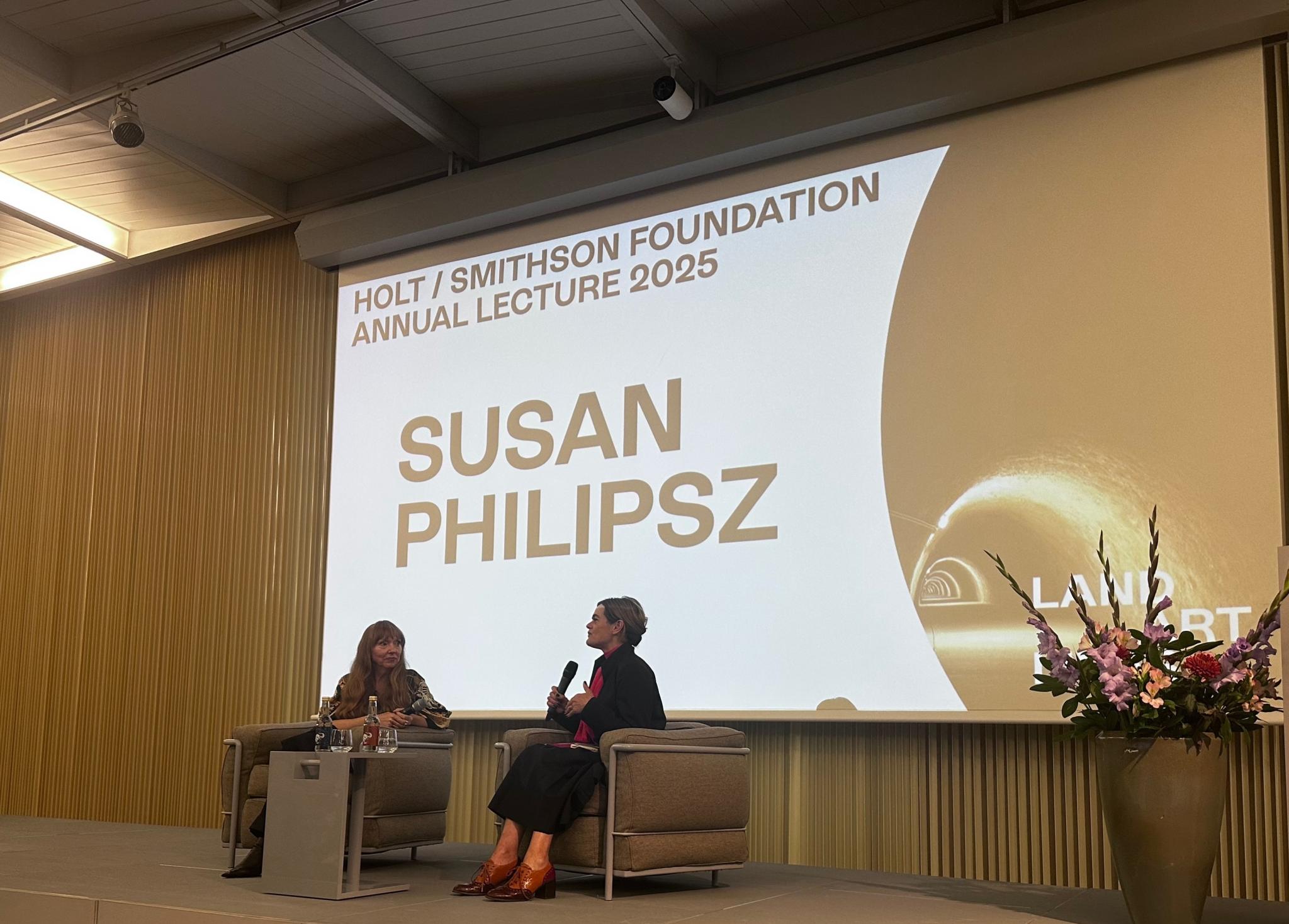 two people discussing ideas on a stage