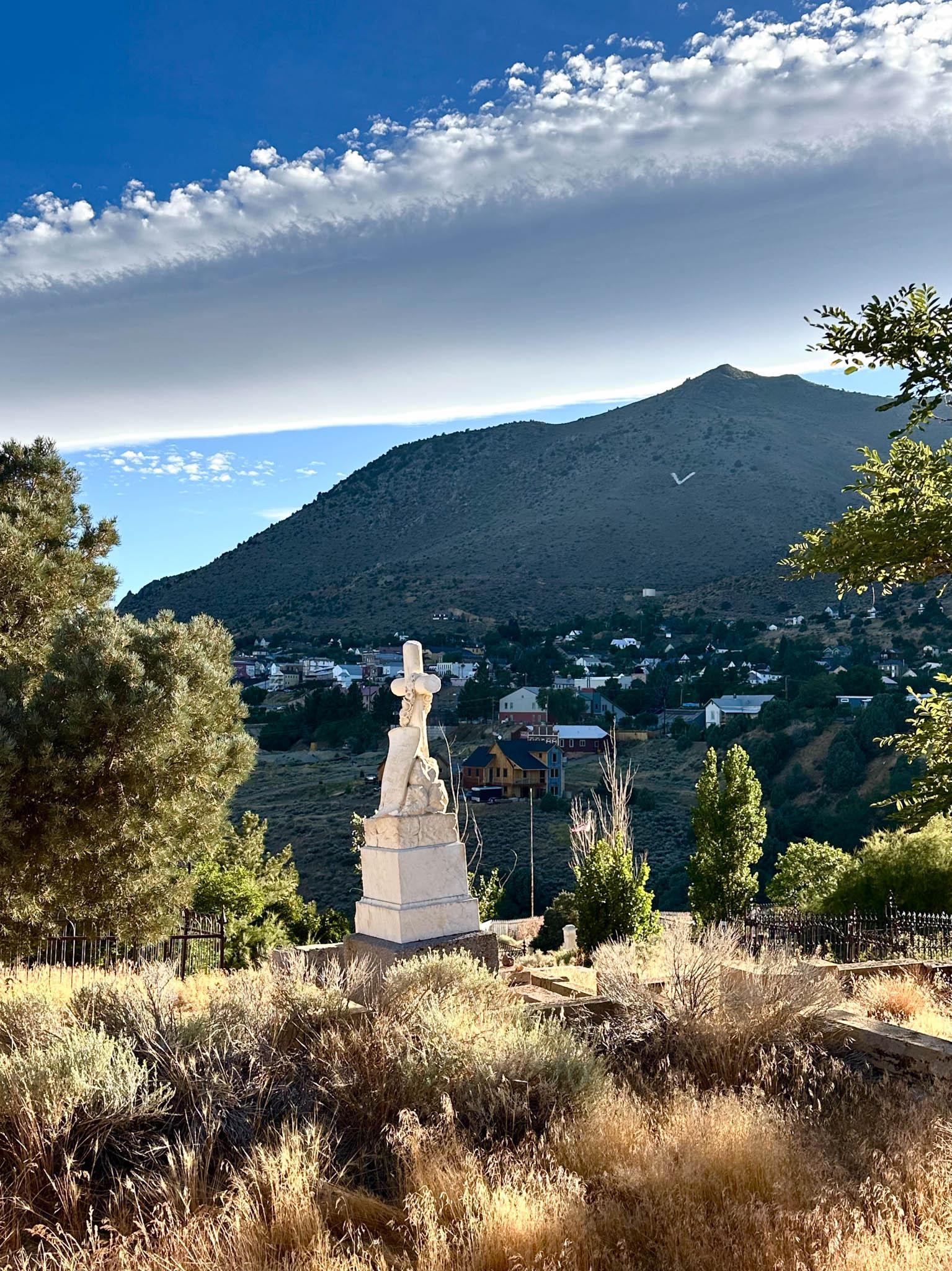a cemetary in a mountainous area looking toward a large mountain