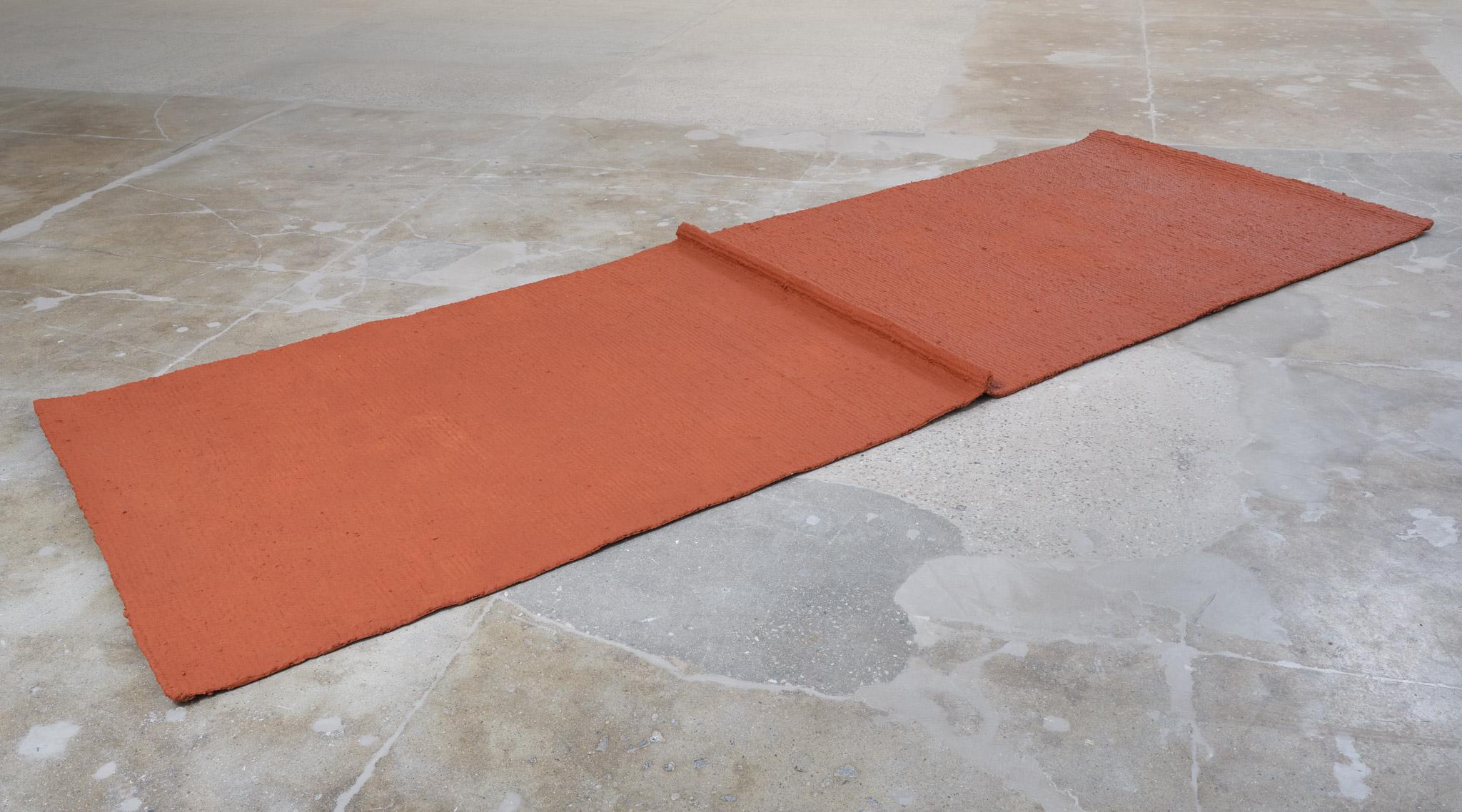 Installation view: Casting a Glance: Dancing with Smithson, Marian Goodman Gallery, Los Angeles, CA, 2025 featuring a jute mat covered with soil by Delcy Morelos