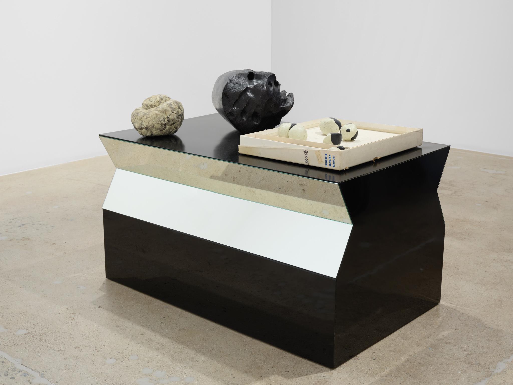 Installation view: Casting a Glance: Dancing with Smithson, Marian Goodman Gallery, Los Angeles, CA, 2025 Formica table with mirrors by Robert Smithson with sculptures by Robert Orozco sitting on top