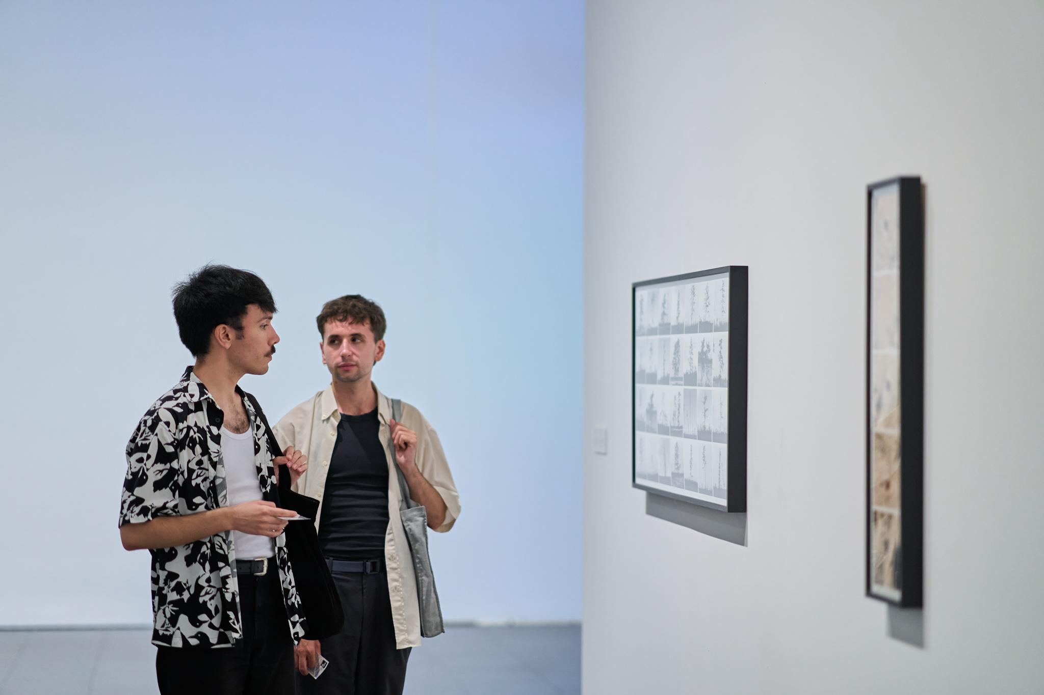 people in a museum looking at art