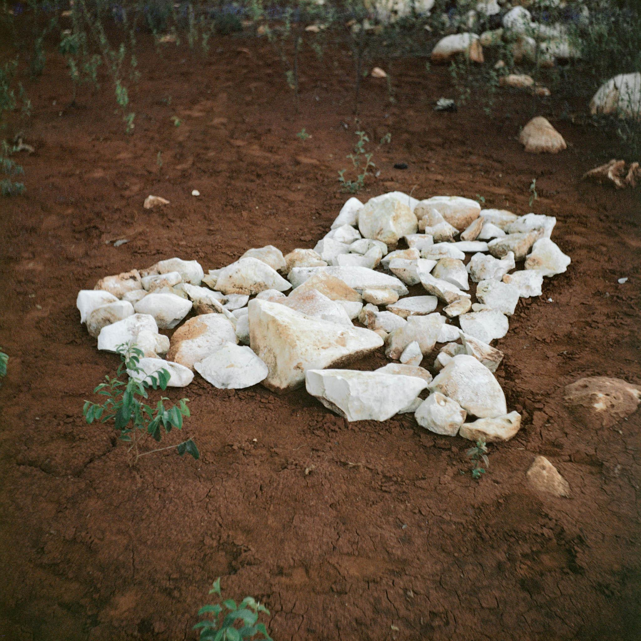 image of an island made from white rocks on dark earth