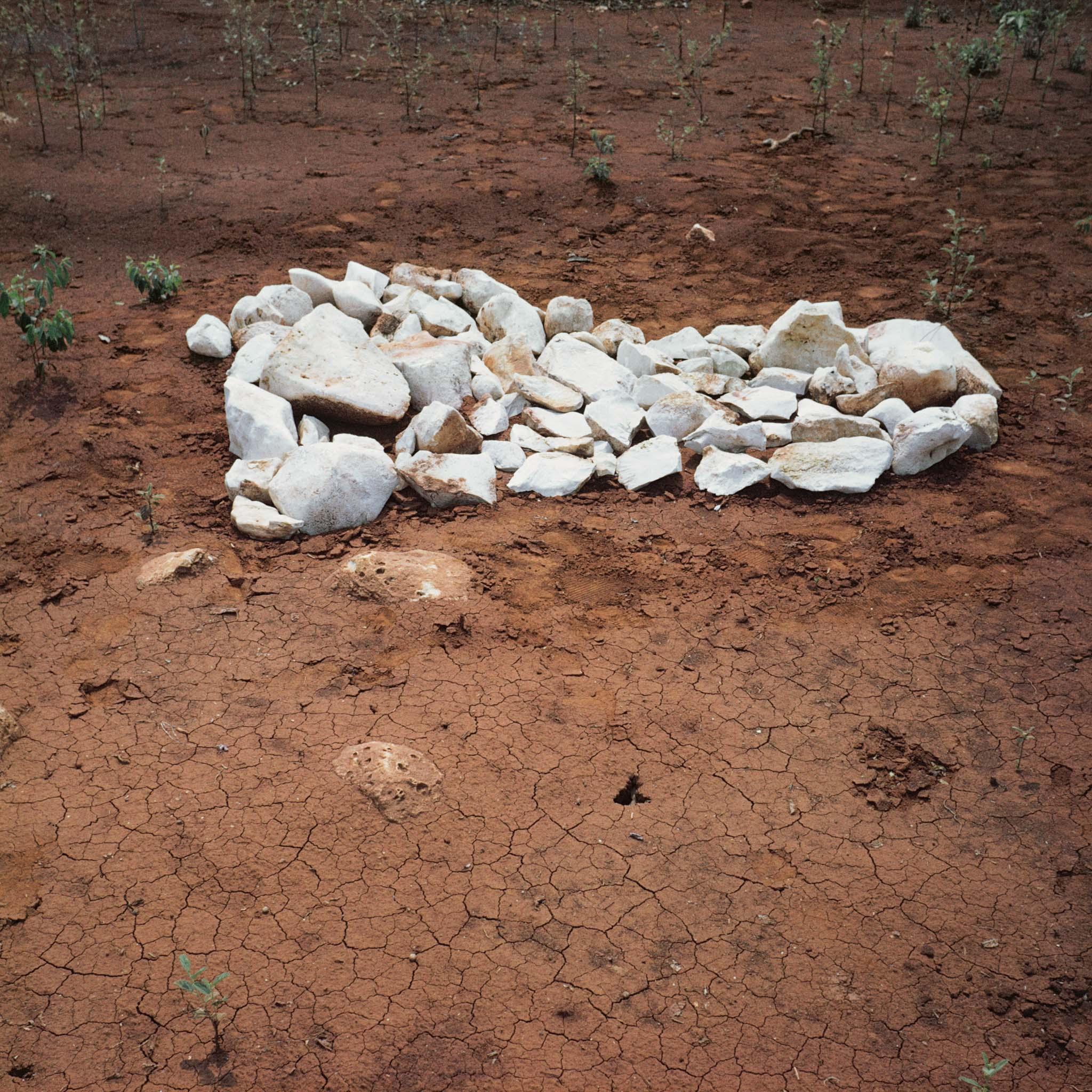 image of an island made from white rocks on dark earth