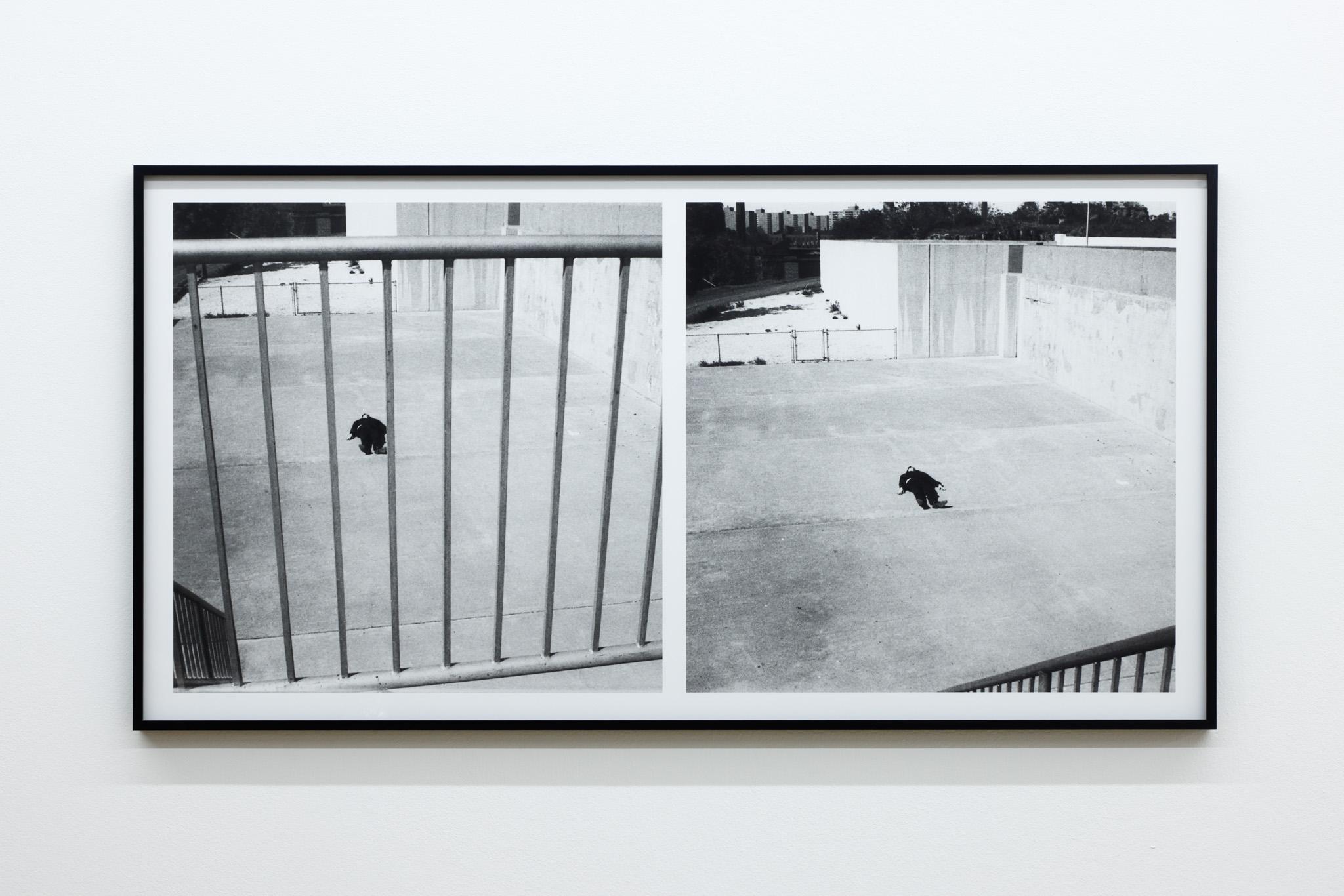 two images of a white man lying on a concrete ground, one seen through railings