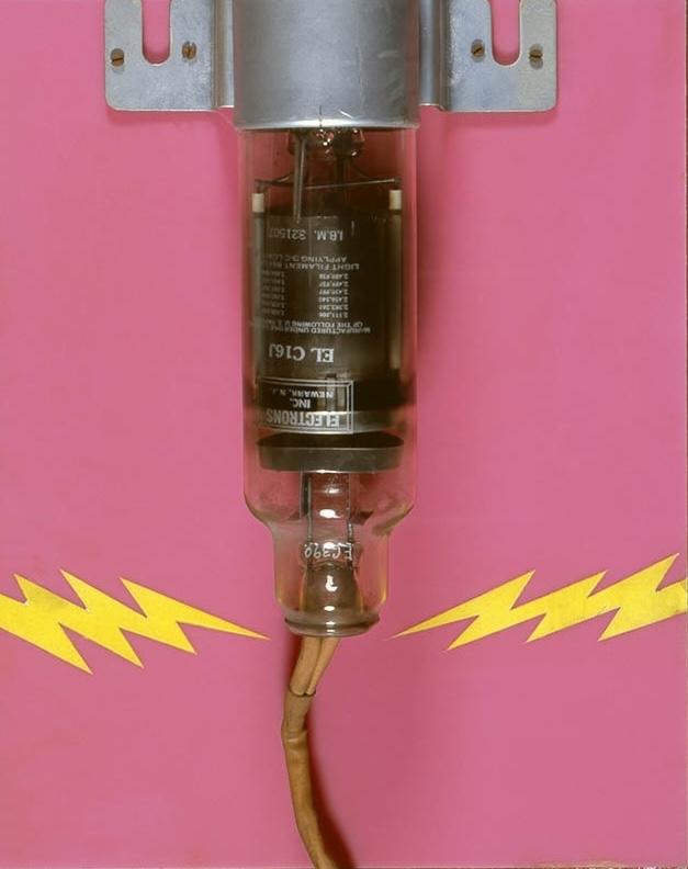 section of a wall based sculpture with collage and a machine