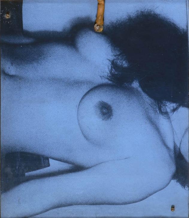 section of a wall based sculpture with collage and a machine