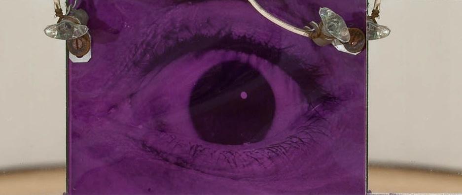 wall based sculpture with an eye at the center