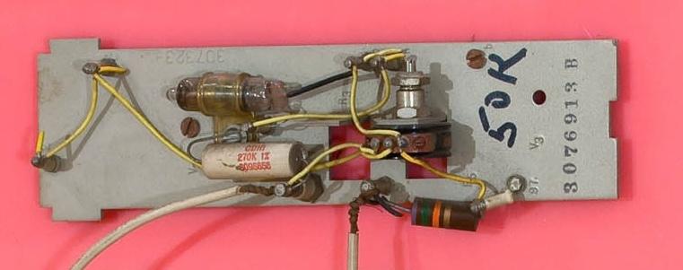 wall based sculpture with an eye at the center