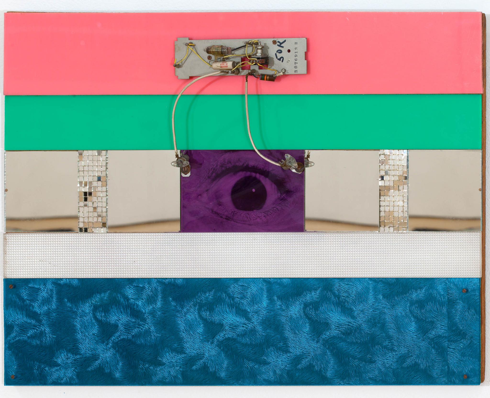 wall based sculpture with an eye at the center