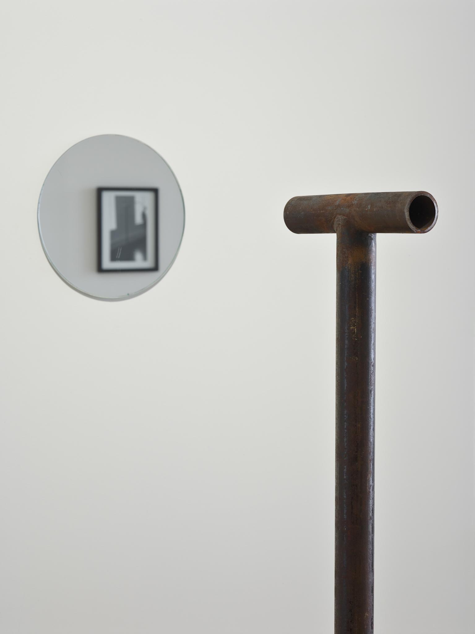 A steel pipe looking toward a mirror