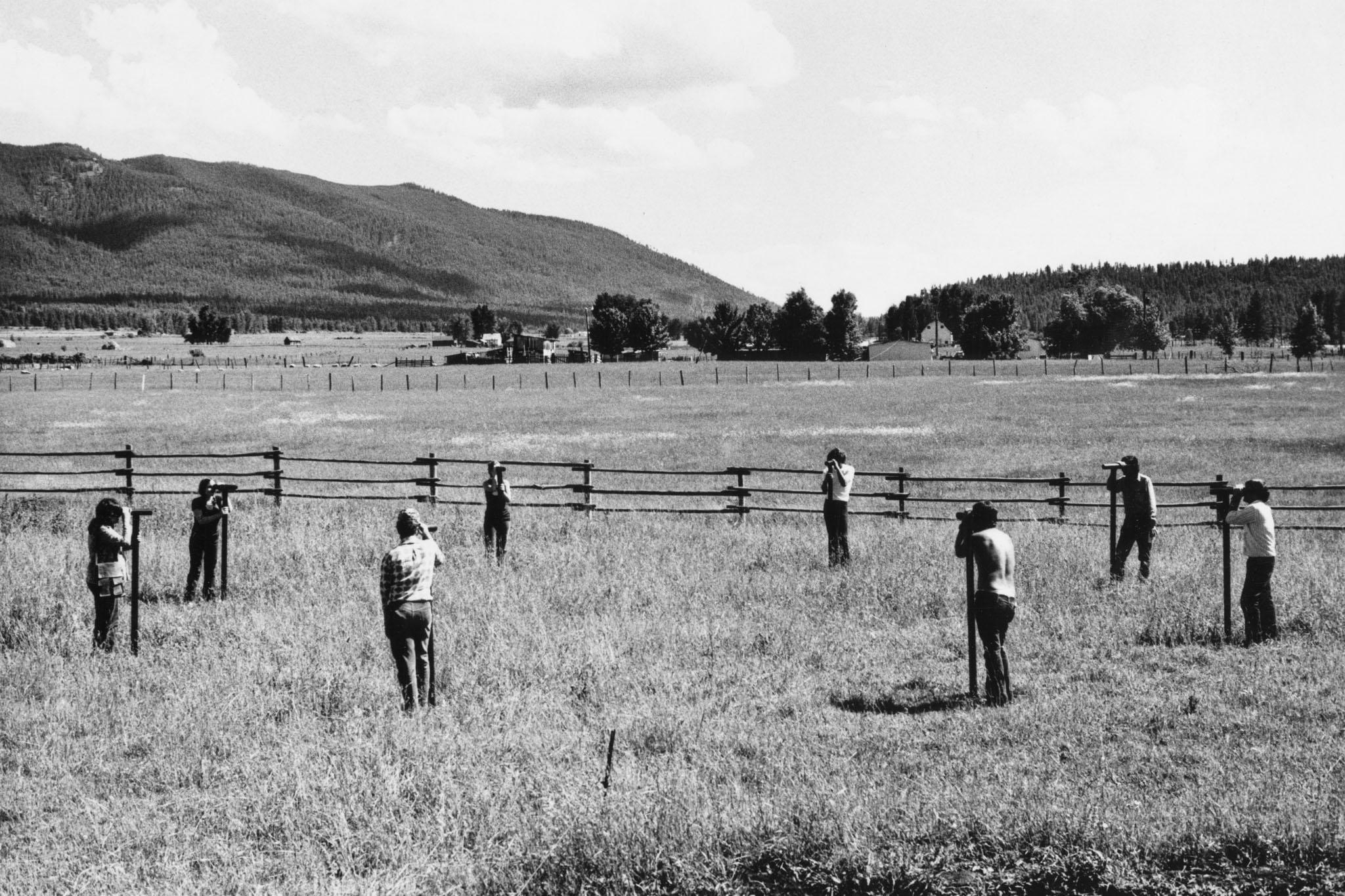people looking through a circle of Locators