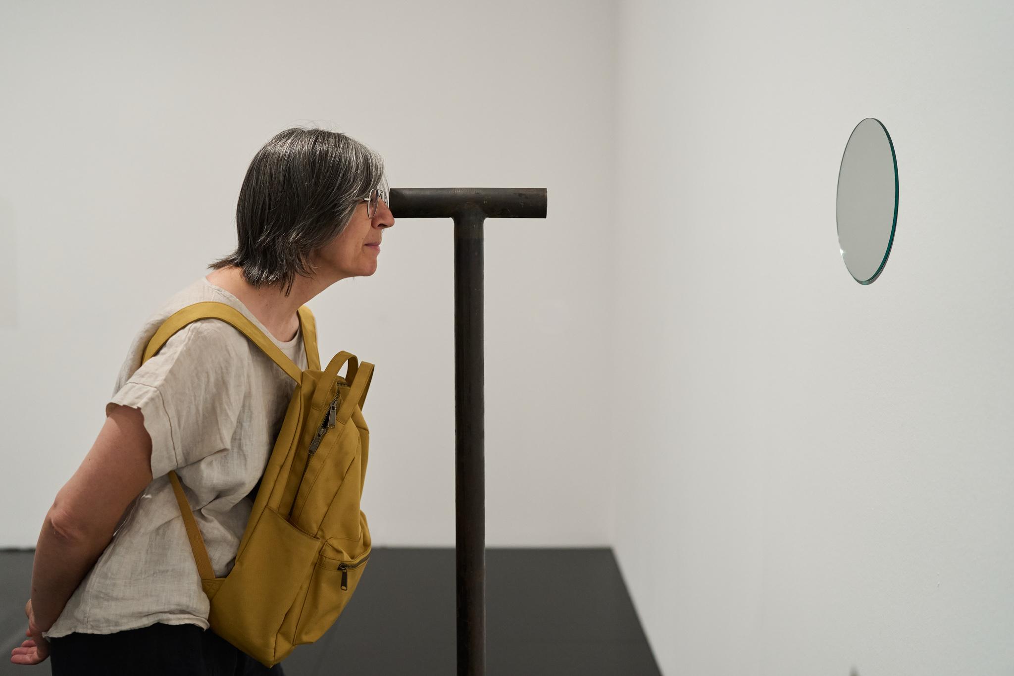 a woman looking through a Locator