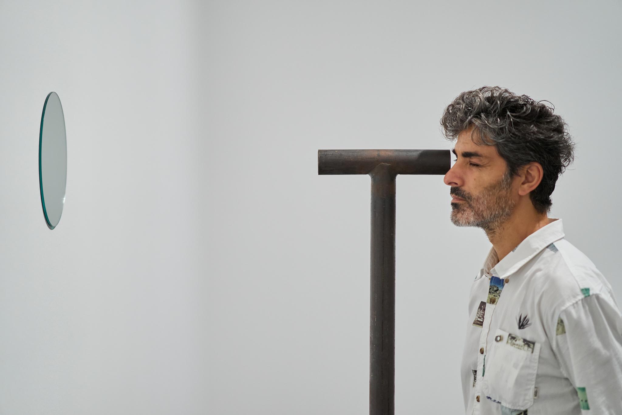 a man looking through a Locator