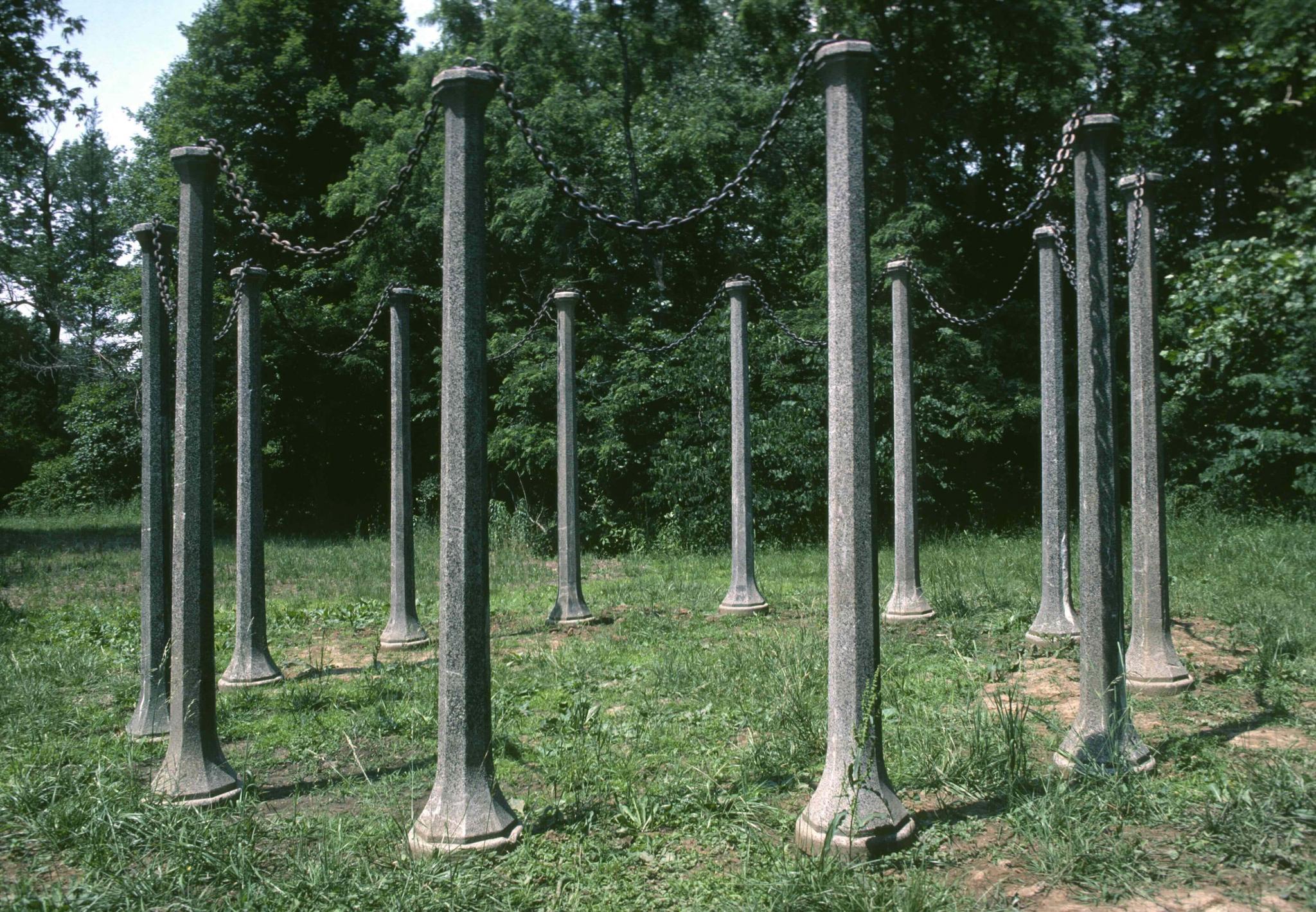 a sculpture comprising a circle of stone posts