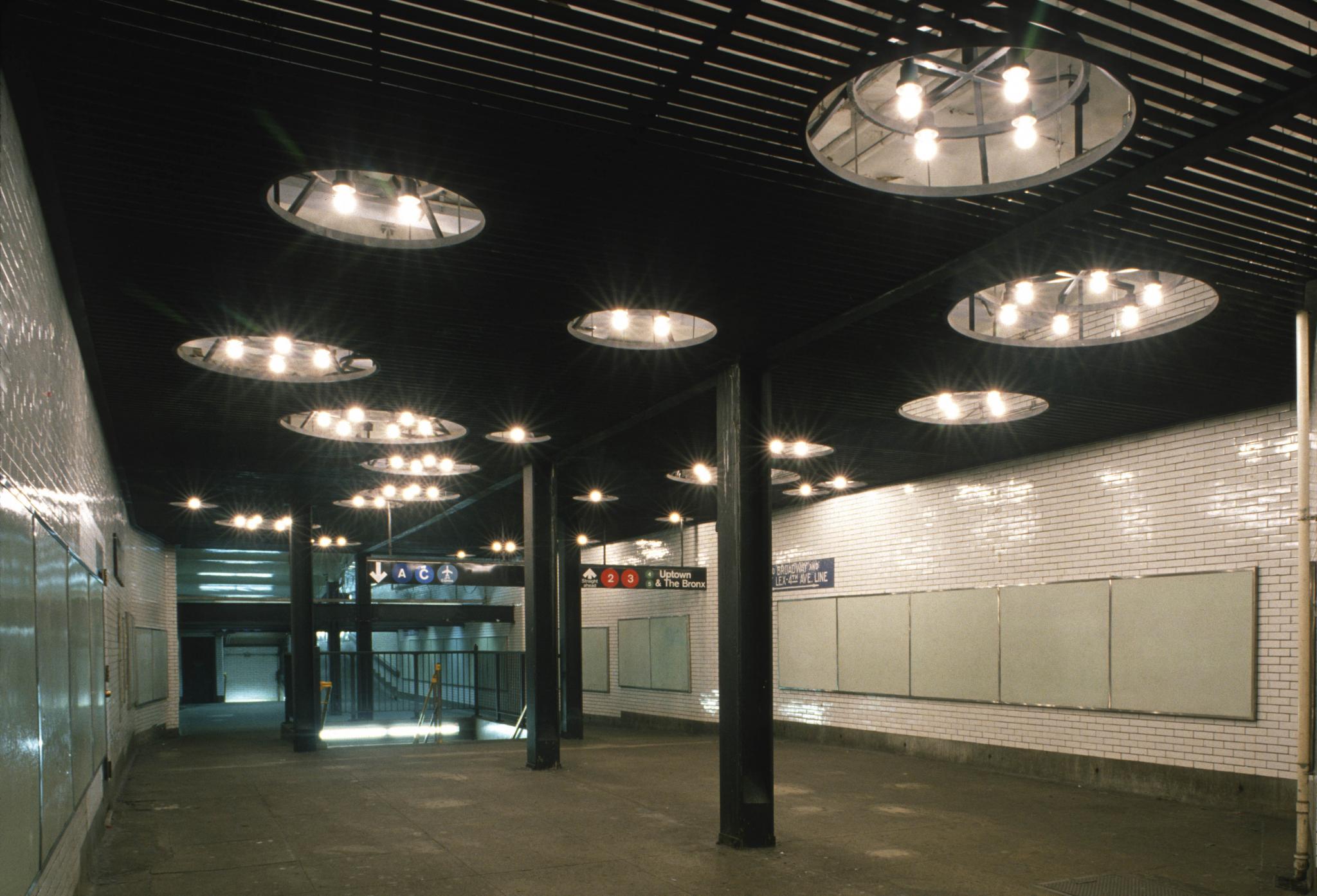 steel ceiling-light sculpture installed in a subway passageway