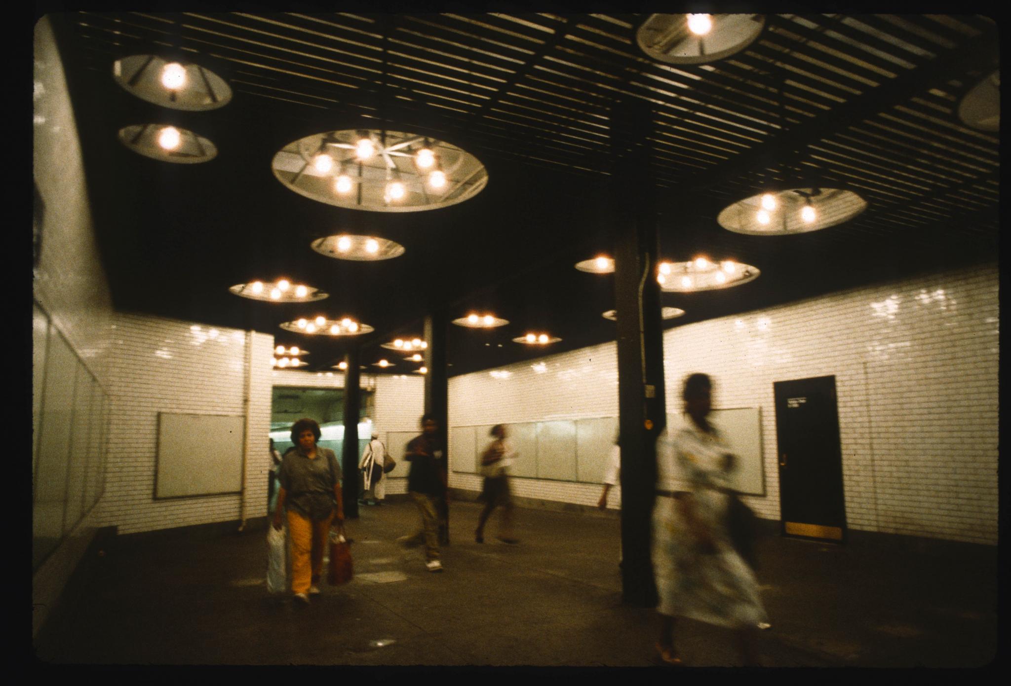 steel ceiling-light sculpture installed in a subway passageway