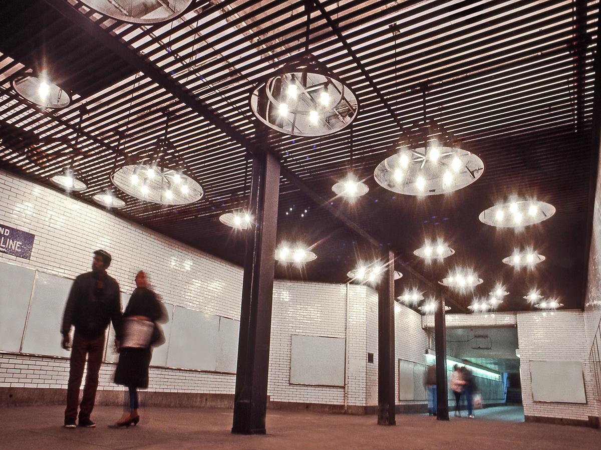 steel ceiling-light sculpture installed in a subway passageway
