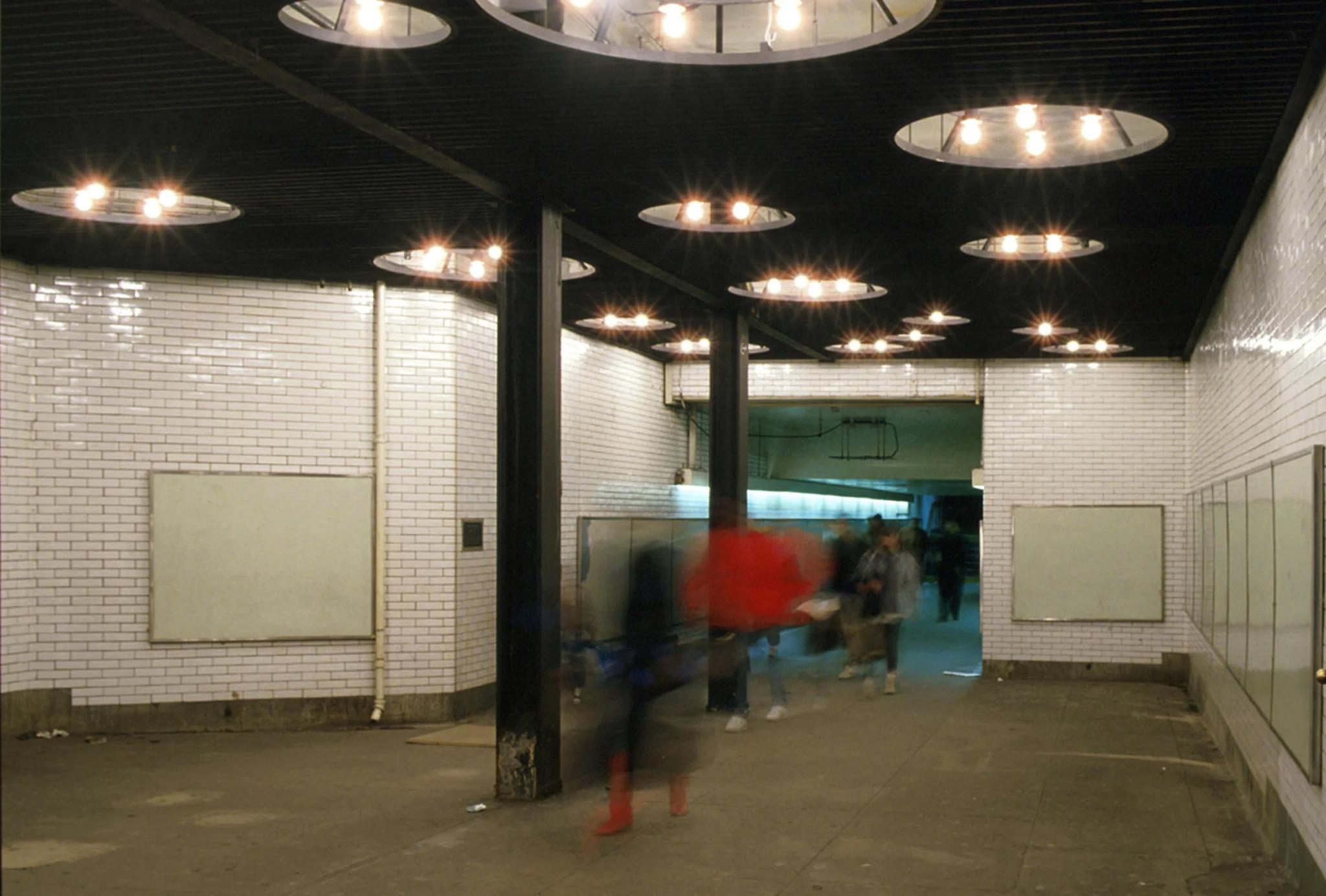 steel ceiling-light sculpture installed in a subway passageway