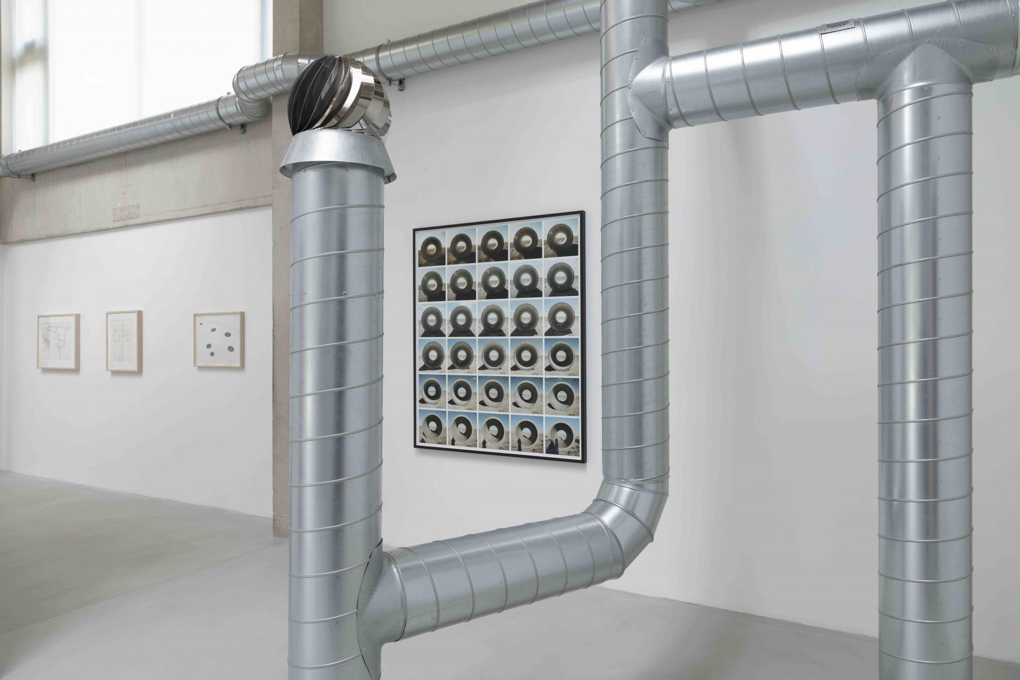 detail of a sculpture made of ventilation pipes with other works