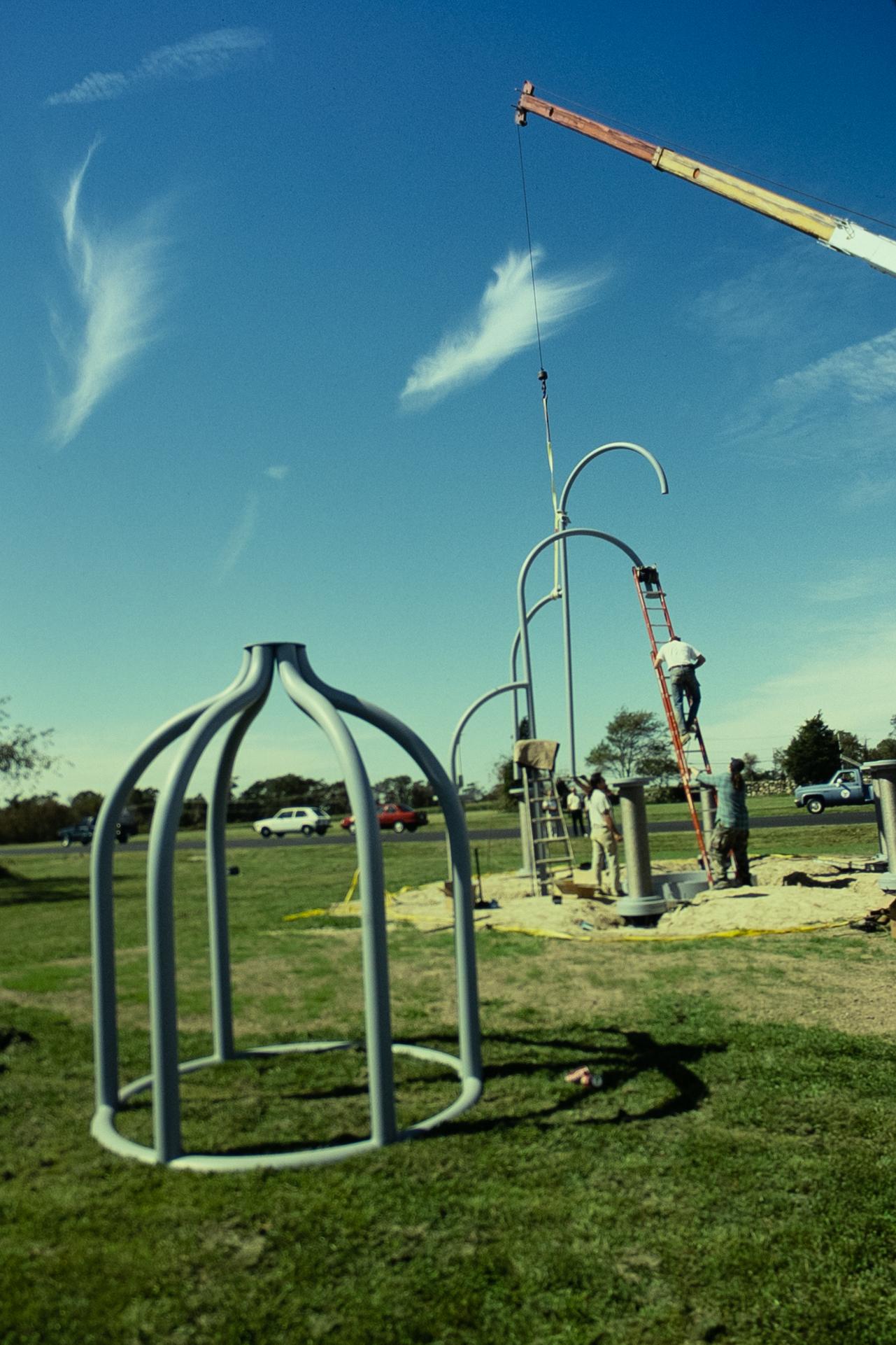 an outdoor sculpture in the form on an industrial device being installed